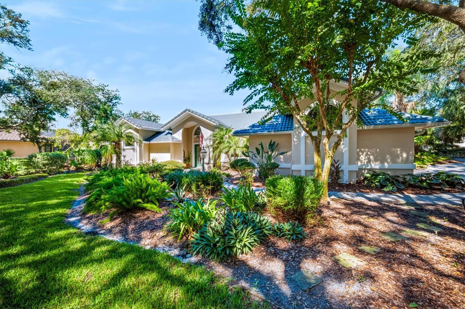 Welcome to 20 San Marco Court in the prestigious private oceanfront community of Hammock Dunes! Situated on a beautifully landscaped homesite overlooking a tranquil lake, this 3 bedroom, 2.5 bath residence offers 2,484 square feet of comfortable living space with an inviting open floor plan, vaulted ceilings, and abundant natural light. The spacious kitchen features granite countertops, stainless steel appliances, generous cabinetry, and a breakfast bar that opens to the living area. A stunning floor-to-ceiling stone fireplace adds warmth and character, while the separate dining room provides an ideal space for entertaining. The primary suite offers a spacious bath with dual vanities, a soaking tub, and a walk-in shower. Step outside to your private screened lanai featuring a sparkling pool, spa, covered seating area, and built-in outdoor grill, all overlooking peaceful lake views. A separate outdoor patio surrounded by mature trees and lush tropical landscaping provides another inviting space to relax and enjoy the Florida lifestyle. To further elevate the Hammock Dunes community lifestyle, membership to the Hammock Dunes Club is available, offering a superior member experience. Amenities include an oceanfront clubhouse and a Low Country clubhouse with formal and casual dining options, two Audubon-certified golf courses designed by legendary architects Tom Fazio and Rees Jones, a 5,000-square-foot ocean-view fitness center, oceanfront pool complex, playground, splash pad, tennis courts, pickleball, croquet, bocce, and more.