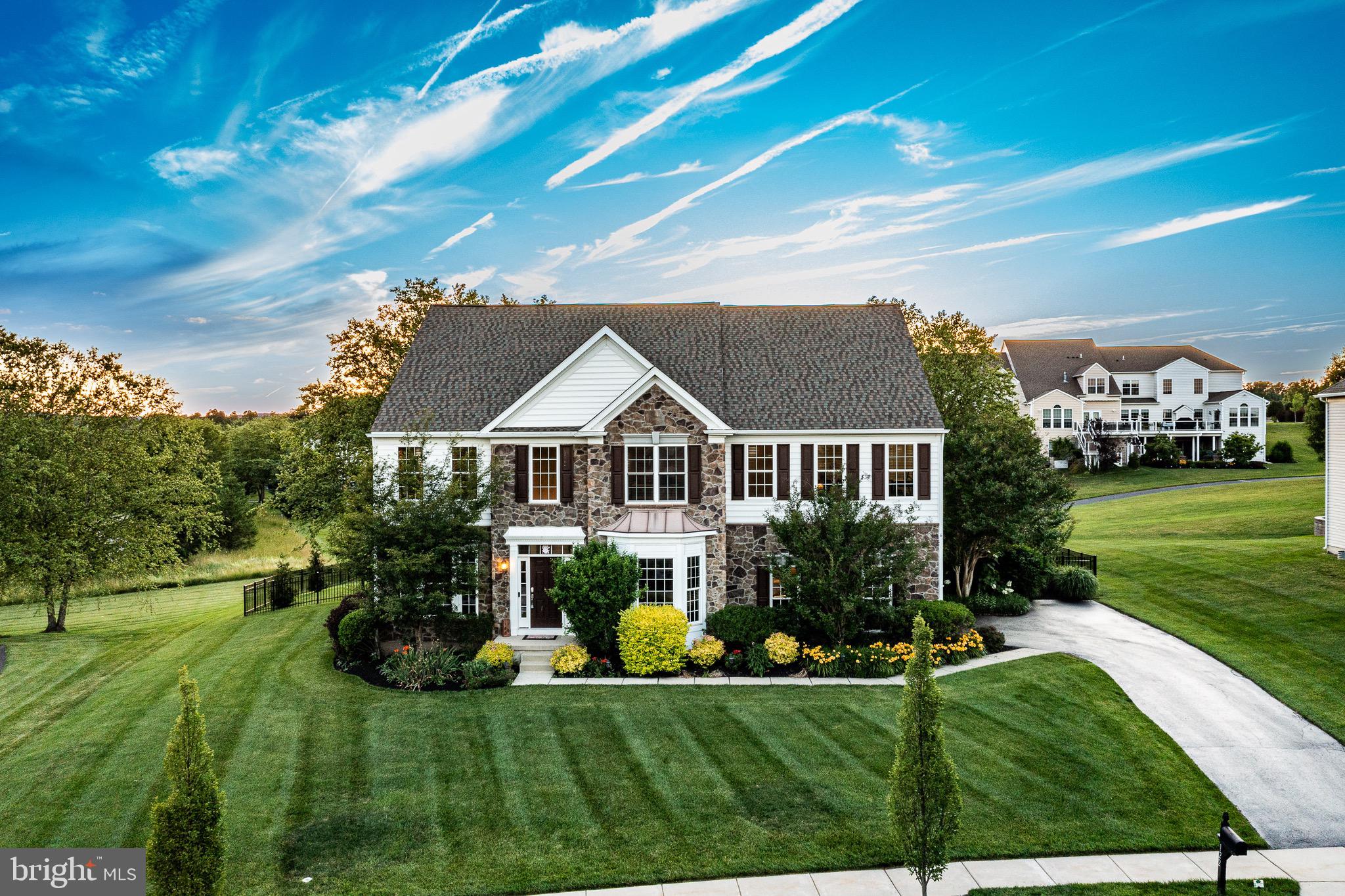 Offering the best builder-upgrades, this  former Monterey Applecross model home offers top-tier amenities & a prime golf course backing flat lot!  Classic stone front elevation greets you & once inside, the elegant 2 story foyer lets you know you’re in for something special. Boasting 4 bedrooms & 4.5 baths this larger Applecross “Classic” home will not disappoint!  This former builder model home offers over $220,000 thoughtful upgrades!  The adjacent living room is spacious w/ hrdwd floors,  upgraded trim package & a magnificent decorative window system. Architectural pillars distinguish the adjoining DR, w/oversized windows &  dentil crown molding. The modern kitchen offers expanded industrial grade hrdwd flr w/ granite countertops to a large center island &  breakfast bar. Premium SS appliances include a double wall oven & built-in gas range. This is a beautifully updated kitchen featuring resurfaced cabinetry w/ crown molding, a designer tile backsplash &  premium 5-burner gas range w/ externally vented exhaust hood.  Convenient butler’s pantry.  At the rear of the home, you'll find a spacious, light-filled Florida Room overlooking the golf course. This premium builder upgrade added valuable sq ft beyond the standard model, creating an inviting space that's perfect for relaxing, entertaining, or enjoying the scenic views year round.   A cozy yet spacious FR w/ decorative wood beams, a gas fireplace & floor-to-ceiling windows  bathe the area in natural light.    Upstairs, you’ll find the huge master suite w/tray ceiling, recessed lighting & a lrg split dual room style w/plenty of flexibility such a sitting area/ exercise rm option. A lrg W/I closet provides plenty of storage options. An expanded window system overlooks premium golf course views. Completing the suite is the tile bt w/cathedral ceiling & double vanity,   stall shower & separate soaking tub! The 2nd bdrm is a spacious princess suite w/lrg tile bth. The 3rd & 4th bdrms are generously-sized w/ lrg closets & share a Jack & Jill  bth w/lrg double vanity. New carpet  throughout the 2nd floor. The premium walk-up finished basement provides a possible 5th bedroom, add’l living & entertaining space. The theatre area w/custom built-in entertainment area featuring a Dolby Atmos set up. The large rec room offers  finished space perfect for billiards, & entertaining etc. Enjoy the lush grounds offers upgraded & established landscaping backing to the 2nd fairway and green of the golf courses prided 2nd hole.  An enormous hardscaped patio w/ built in seating, built in fire pit, built in grilling & counter space make it easy for hosting.  The flat  fenced in back yard is perfect for recreation and enjoyment.   Enjoy piece of mind as the home includes a new roof, new front door, upgraded electrical system, a new hot water heater, and Whole house generac generator- ensuring comfort and reliability year-round!!  Final features include an oversized 2 car garage,  driveway w/ plenty of parking , upgraded technology features including -- a EV charger, Ring security system, Nest thermostats, smart locks, & wired high-speed internet infrastructure throughout. The organization & attention to detail of this home cannot be overstated. This is a perfect location right in the heart of the Country Club, overlooking the golf course & only steps away from the community pools, tennis, & fitness center! Applecross CC is conveniently located near parks, shopping, & restaurants!  Conveniently located near major travel routes including Downingtown & Thorndale Train Stations, , Rt 322, Rt 30, & Rt 100 & PA Turnpike.  Award-winning Downingtown Schools, STEM academy, & take advantage of all that Applecross offer: state of the art fitness center & -Studio T- exercise/dance studio, indoor & outdoor pools w/Caribbean pool bar, Nicklaus-designed golf course, tennis, fitness classes, social events/parties, full restaurant/bar, family event basketball & more! Applecross - Live Where You Play!