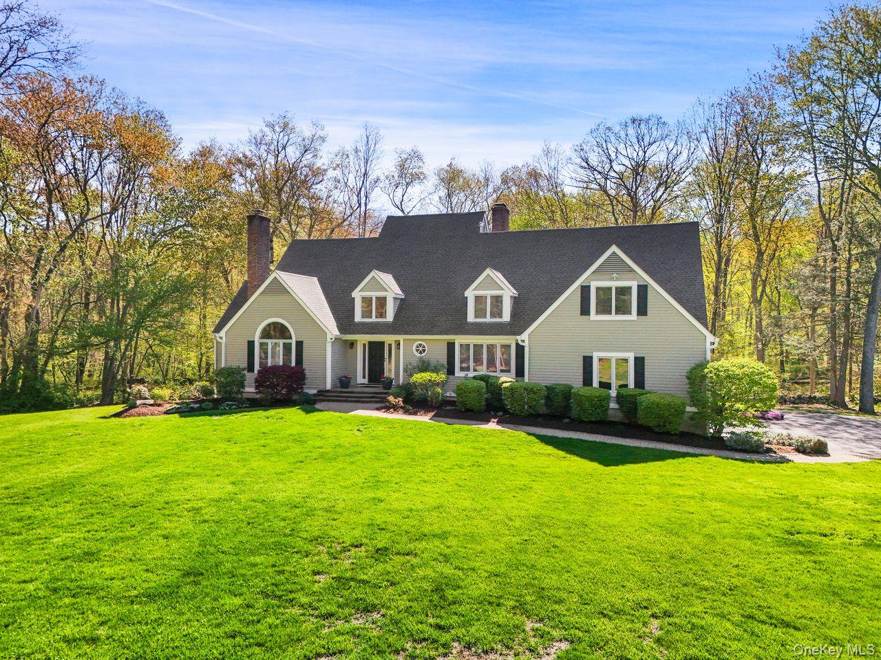 Set on 3.73 acres this elegant 4-bedroom, 2.5-bath colonial offers soaring ceilings, expansive windows and exceptional privacy. A dramatic double-height entry welcomes you into the home.  A formal living room and a stunning great room with cathedral ceilings both featuring wood-burning fireplaces. The spacious kitchen is complete with a center island, breakfast nook, and access to a full house length rear deck which overlooks the serene private back yard. The first-floor primary suite also on this level is a private retreat with high ceilings, a walk-in closet, a spacious en-suite bath, and direct access to the deck. A powder room, formal dining room, laundry room and access to the garage round out this level. A grand staircase brings you to the second level which consists of 3 bedrooms, one with its own sitting room, a full bathroom with 2 sinks and a bonus space currently being used as an office. The unfinished basement spans the full footprint of the main level and offers plenty of storage as well as endless possibilities. A set of sliders to the outside make accessing the back yard a snap.The level, sprawling yard surrounds the home while matures trees  in the back offer exceptional privacy year round. Part of the Katonah Lewisboro School System. 8 miles to major highways and the Katonah train station.