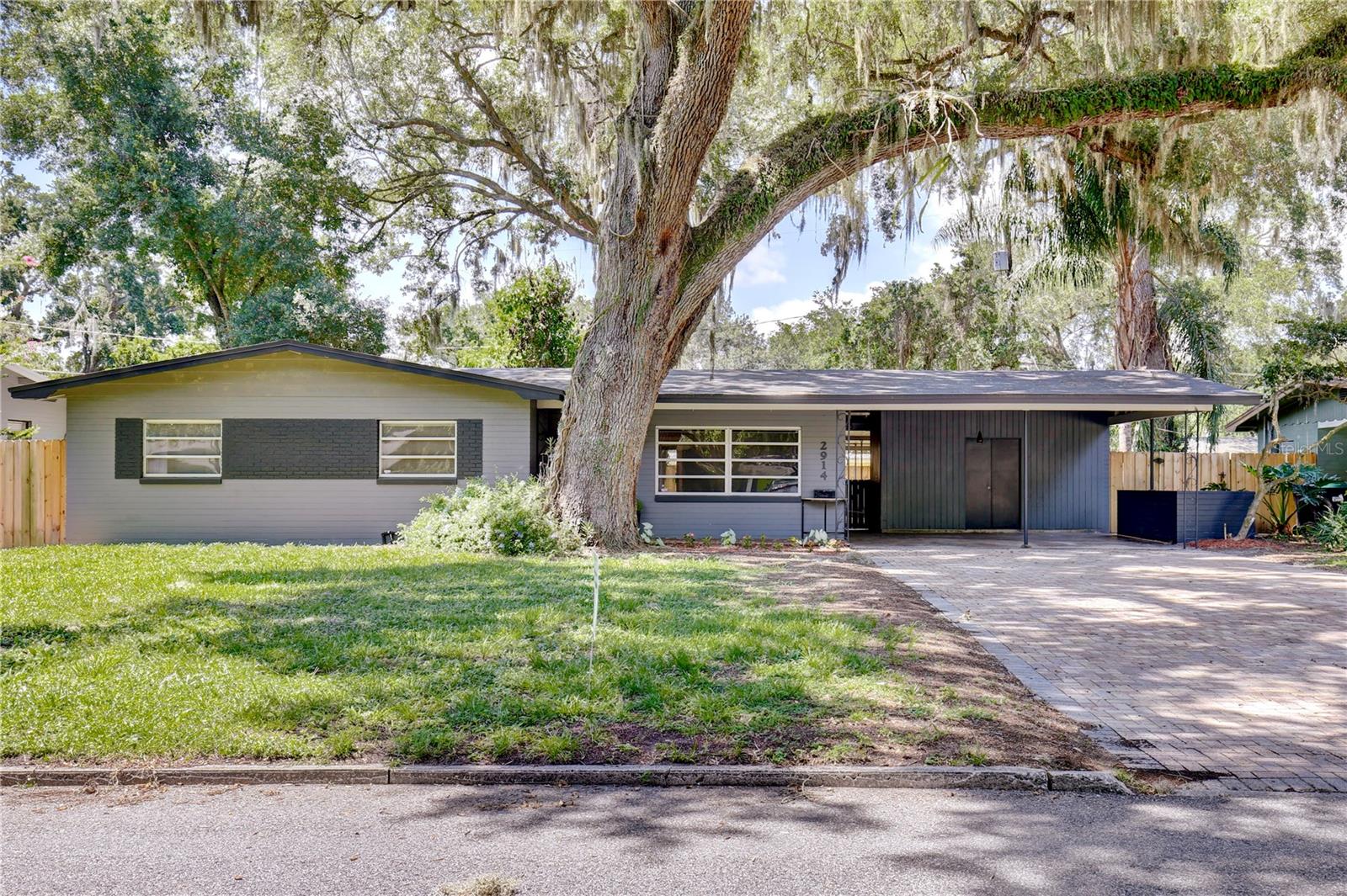 Welcome to this beautifully updated, move-in ready home located in the highly desirable Conway area of Orlando. From the moment you arrive, the exceptional curb appeal captivates you with mature trees, lush landscaping, a beautiful paver driveway, and a shaded carport leading to an inviting front porch. Step through the modern front door into an open and airy, freshly painted interior boasting an abundance of natural light, neutral colors, and gorgeous wood-style flooring. The open floor plan seamlessly flows from the spacious living room into the dining area, where sliding glass doors open to a private screen-enclosed patio perfect for outdoor entertaining. The light and bright kitchen is a chef’s dream, featuring classic white shaker cabinets, stylish tile backsplash, stainless steel appliances, and gleaming granite countertops. A convenient side door leads directly to the carport, which hosts an attached versatile laundry room/workshop/storage space. The primary suite serves as a peaceful retreat, showcasing modern frosted glass closet doors and an upgraded en suite bathroom complete with a contemporary vanity, updated fixtures, and a sleek glass door shower. Two more welcoming guest bedrooms offer ample space for family and friends, sharing a luxurious second bathroom equipped with a beautiful tub/shower combo and a chic vanity. Out back, the expansive, fully fenced and private backyard provides a safe haven for pets and a blank canvas for weekend barbecues or gardening. Perfectly situated in a prime Orlando location, this home is just minutes from downtown, the popular Hourglass District, and major roadways like I-4 and 408, providing quick access to world famous theme park attractions and the Orlando International Airport. Students can attend top tier schools, including Pershing Elementary and the highly rated Boone High School.Monthly Rent: $2800 includes lawn service and washer & Dryer for your added convenience.Security Deposit starts at $2800.Application Fee: $100 per person over 18 yrs old. Rental Criteria applies so inquire within before applying. Don’t miss out on this incredible gem—schedule a showing today!