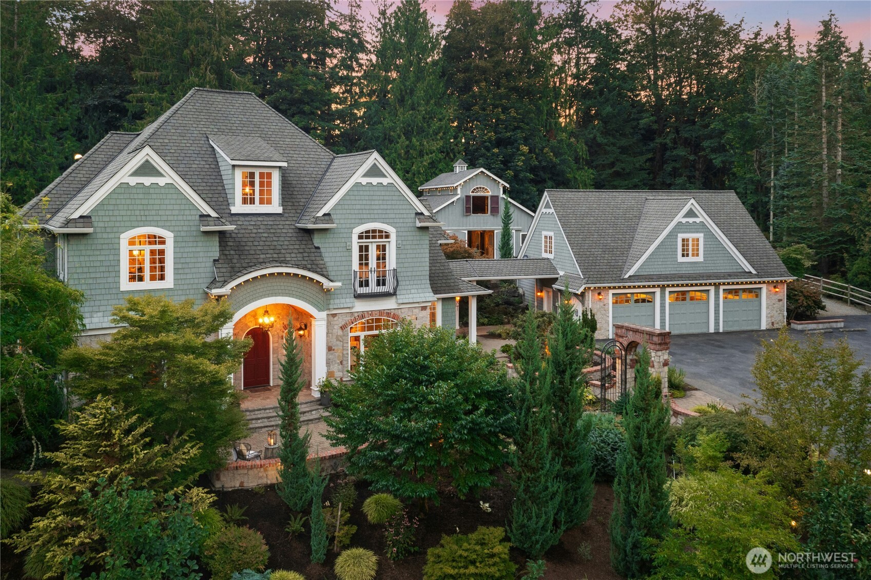 Experience timeless craftsmanship, modern comfort, and serene country living on this seven-acre legacy estate in the award-winning Lake Washington School District, just minutes from Microsoft, SpaceX, and Eastside tech. Wake up to peaceful views of open pastures, a spring-fed duck pond, and professionally designed gardens with winding paths, stone walls, and archways—your own private retreat. Designed for both equestrian and non-equestrian living, the grounds feature fenced paddocks, a turreted viewing area above the irrigated arena, and a beautifully maintained 3-stall matted barn. Inside, warm hardwoods, marble surfaces, solid white oak cabinetry, and Pella Architect Series windows showcase exceptional quality. The gourmet kitchen with dual sinks and dishwashers is made for gathering, while the wood-paneled library with balcony, two-story primary closet, and wine cellar add moments of everyday luxury. Expansive patios and covered outdoor living with a natural-stone fireplace overlook a hillside water feature surrounded by mature Japanese maples. The private ADU above the garage offers flexible space for multigenerational living, guests, or support. Elevator access, Tesla charging, whole-property generator and Wi-Fi, private well, automated systems, and low-maintenance landscaping. An extraordinary blend of tranquility, luxury, and convenience—truly a rare estate.