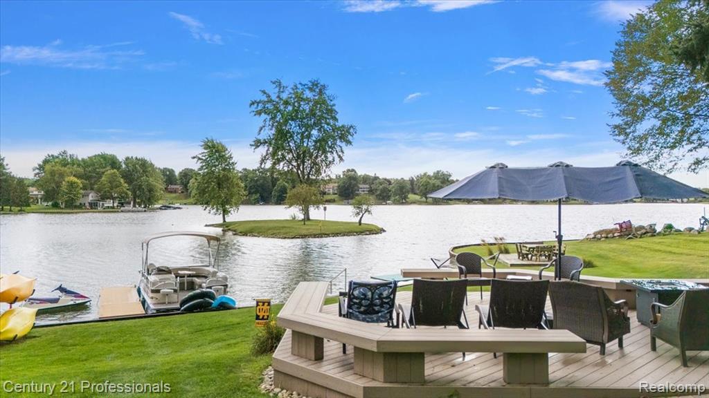Private ALL SPORTS 80-acre Lake Metamora offers boating, waterskiing, tubing, paddleboarding and year-round recreation, stocked annually with walleye, bass and pike—all just minutes from Oxford and Lapeer. The property embodies true lakefront living with a lakeside deck, large shed and a small island—a rare find. Recent updates include a NEW ROOF  (2024), FULL KITCHEN RENOVATION (2022) and fresh exterior paint. The chef’s kitchen by architect Paul Delave features custom Amish cabinetry, quartz counters, premier appliances and a striking brick statement wall. Perched above the vaulted sunroom, it opens through a large cut-out to sweeping lake views, with a custom-lit wine bar and large island for entertaining. The four-season sunroom, encased by floor-to-ceiling windows, showcases a vaulted ceiling, exposed beams and a stone fireplace. From the sunroom and dining room—complete with fireplace, built-ins and bay window—step onto a brick-paver patio with panoramic south-facing views. Four spacious bedrooms each have walk-in closets; the primary suite offers a spa bath, soaking tub and walk-in shower, while a second primary suite also enjoys lake views. Hardwood floors, Anderson windows, first-floor laundry, a two-car garage and extra parking pad complete this rare retreat—perfect for year-round family living, multi-generational needs, or a convenient “Up North” weekend escape close to home. Close to many golf courses including Metamora Golf & Country Club, Copper Hills, Boulder Point and Devil’s Ridge and several hunt clubs including the Huntsman and Metamora Hunt Club.