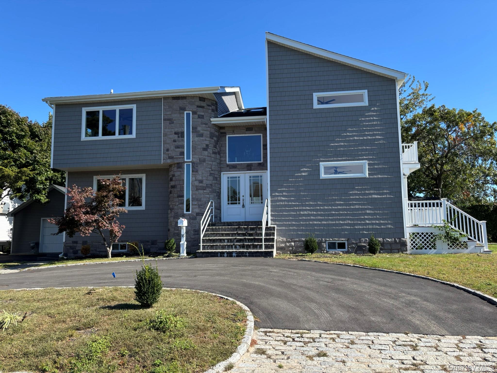 welcome to this waterfront contemporary colonial,fully renovated,this baysidewaterfront home has incredible views,great room has full wall of new sliders overlooking water, new trex decking from first and second floor decks,great roomfeatures beautiful stone fireplace,gorgeous new kitchen with center island, white shake cabinets,quartz counertops,new appliances, french doors open to lovely den,half bath,second floor has 4 all large bedrooms, master bedroom features vaulted ceilingan walls of glass overlooking serene waterfront views, an door leads out to your own private deck,master bath is breathtaking featues vaulted ceiling ,huge seperate shower ,double sinks, soaking tub with winows looking at stunning waterviews so many extras in this stunning home