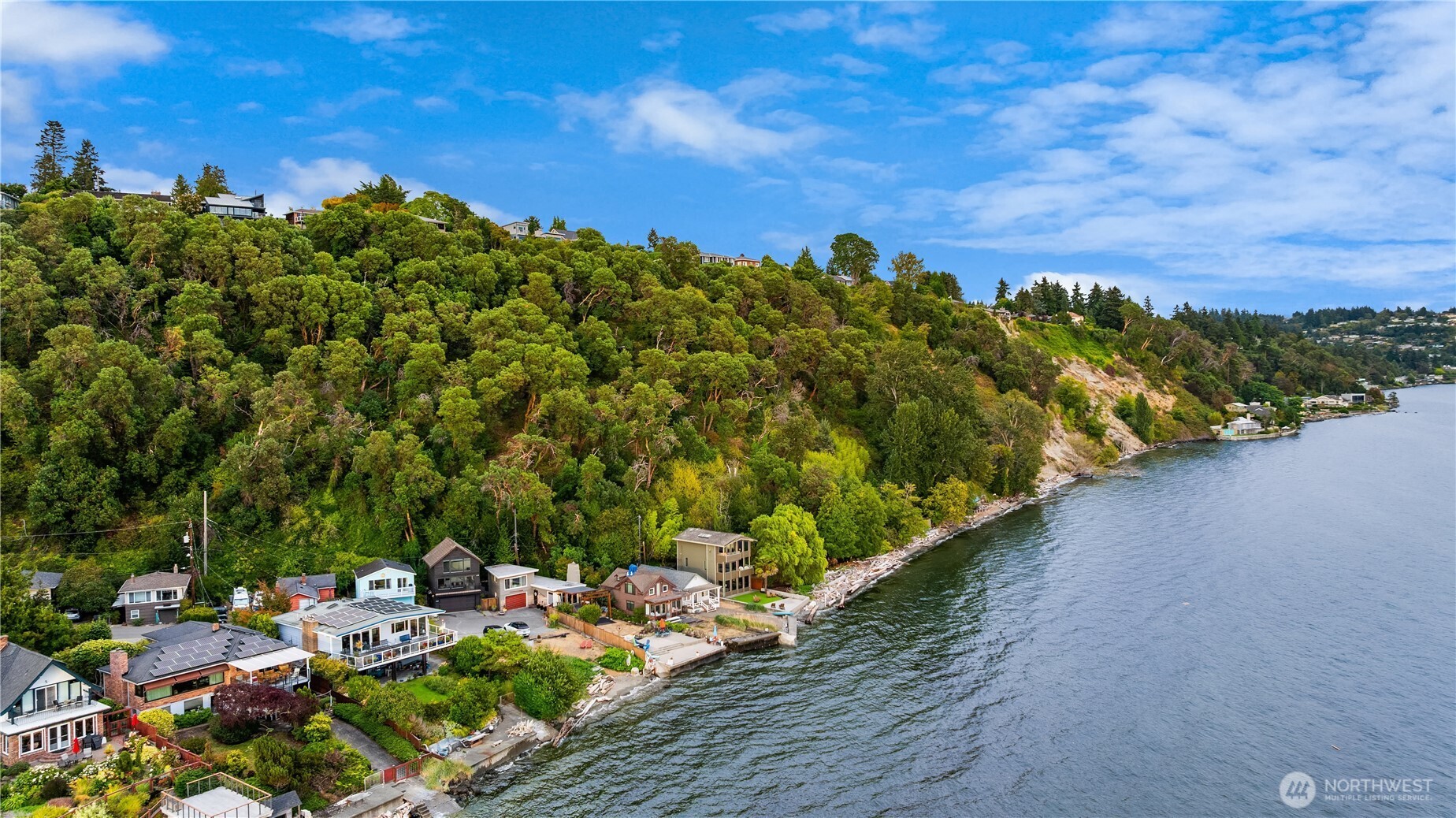 At the water’s edge in West Seattle’s treasured Arroyos community, a truly exceptional setting awaits. With 30' of prime Puget Sound waterfront, commanding 180-degree views and a remarkable sense of seclusion, this incredible residence captures everything that makes waterfront living in the Pacific Northwest so extraordinary. The home unfolds toward the Sound, with a dramatic expanse of west-facing glass across the main level showcasing passing boats, marine life, the Olympic Mountains and sunsets that transform the horizon night after night. A dedicated office makes working from home considerably more inspiring, while the second-level deck provides an irresistible setting for morning coffee as the sun disappears behind the Olympics. Upstairs, the primary suite feels like a retreat all its own, where panoramic views take center stage, complemented by an impressive walk-in closet and enough space to create a true private sanctuary. Wake up to the movement of the Sound, with the western sky putting on its nightly show - all without leaving your bedroom. The property’s position adjacent to Ocean View Park means there is no neighboring home to the east, adding an uncommon feeling of privacy and breathing room. Offered exclusively in tandem with 11428 Arroyo Beach Place SW, and first time on the market in 75 years, together these two properties represent a once-in-a-generation chance to own a remarkable pair of homes in the Arroyos.