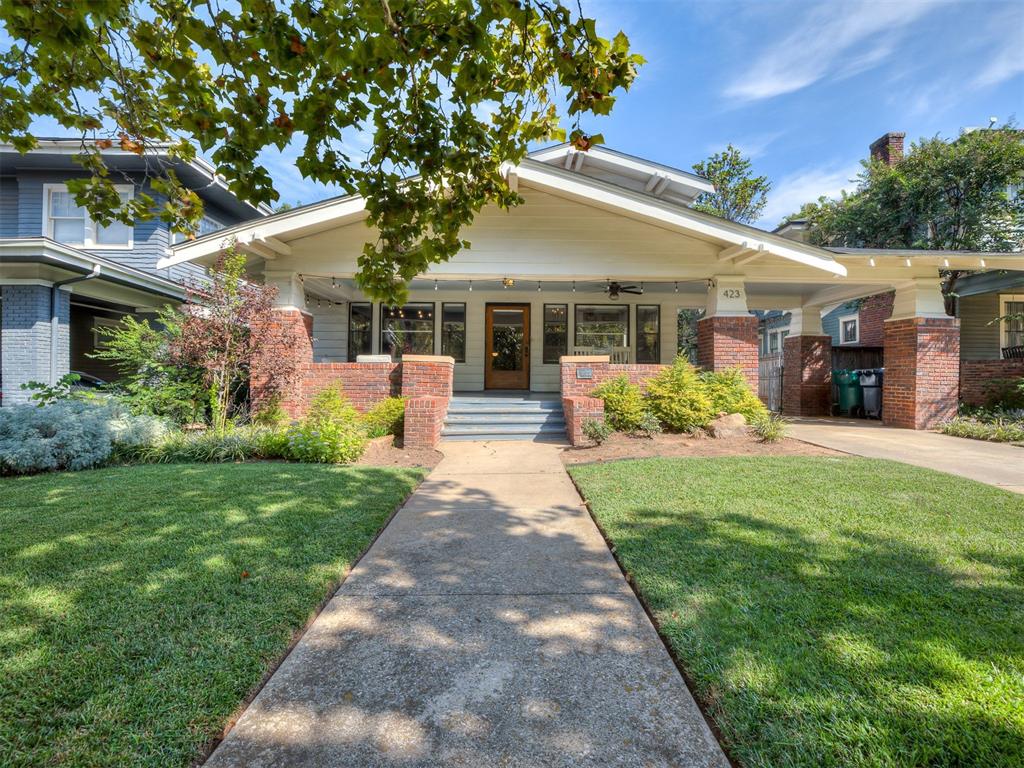 Beautifully remodeled 1918 Heritage Hills Airplane bungalow with a travertine saltwater pool & hot tub added in 2024. A major remodel in 2021 delivered a gorgeous custom kitchen featuring marble counters, brass hardware, and stunning geometric floor tile. The kitchen opens to a breakfast nook with a stylish banquette with storage and a hidden laundry cabinet, keeping everyday function neatly out of sight. Refinished hardwood floors show out through the living and dining rooms. The primary bedroom sits on the first level adjoining an updated bathroom with marble tile flooring. Upstairs, two additional bedrooms share a full bath with marble tile flooring. An oversized covered front porch looks out over beautiful 19th Street and your very own two towering, majestic sycamore trees. The backyard is the finale, a low-maintenance concrete tile patio leading to a travertine saltwater pool and hot tub combo alongside a 300 sqft putting green.  Pure oasis.  Home also comes with an EV charger.