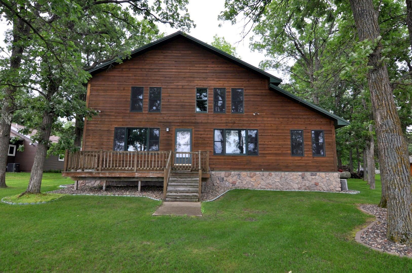 Stunning west-facing home with sunset views on Leech Lake with 100 ft of sandy shoreline.  Discover breathtaking big water views and unforgettable sunsets from this spacious home nestled on a level lot with a short set of stairs at the lakeside.  Designed for comfortable lakeside living, this 3,000 square foot, three-level home welcomes you with a charming 3-season porch that leads to a bright and airy sunroom. The main floor boasts an open-concept design with expansive windows framing the lake, a large bedroom, main-floor laundry, and a full bathroom. Upstairs, the loft offers additional living space, stunning lake views, and another large bedroom with a half-bath. The lower level features a spacious third bedroom that would benefit from the addition of an egress window. The compliant septic system is sized for a three-bedroom home. There is a large recreation room, a ¾ bath, a cedar sauna , a hobby room, and a utility room with a generator panel. There is a whole house generator that is included in the sale. Outside, you'll find a paved driveway, heated and insulated three-car garage with openers, along with an additional two-car garage, offering ample storage for vehicles, boats, and lake toys. Don't miss the chance to experience serene lakeside living with unmatched views from this exceptional Leech Lake retreat!