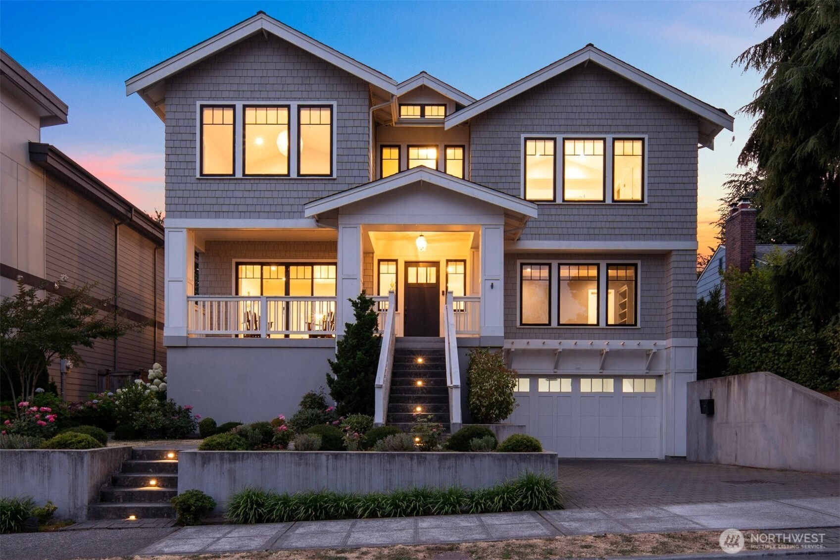 Residing atop Seattle’s coveted View Ridge neighborhood, this beautifully built Contemporary Craftsman captures the essence of Northwest living with territorial views of the Cascades and Lake Washington. Meticulously maintained and thoughtfully designed across three levels with rare elevator access, the home combines exceptional craftsmanship, sophisticated finishes, and effortless indoor-outdoor living. Sun-drenched interiors throughout the home are framed by oversized Andersen windows and sliders, while custom cabinetry, heated tile floors, and sophisticated solar powered dual-zone heating & AC provide year-round comfort. The main level centers around an extraordinary kitchen with premium appliances, a grand island perfect for gathering family & friends, plus a wet bar with built-in espresso machine—ideal for mornings & evenings. The family room flows seamlessly to a professionally landscaped backyard anchored by a covered seating area with fireplace and TV—an inviting extension of the home year round. The grand staircase welcomes you upstairs to your luxurious primary suite featuring a soaking tub and oversized walk-in closet with direct access to the laundry room, and is complemented by three additional bedrooms and two bathrooms. The lower level offers a guest bedroom, full bathroom, abundant storage, walk-in wine cellar, and a generous great room ideal for movie nights, games and entertaining- all with direct access to a large two car garage.