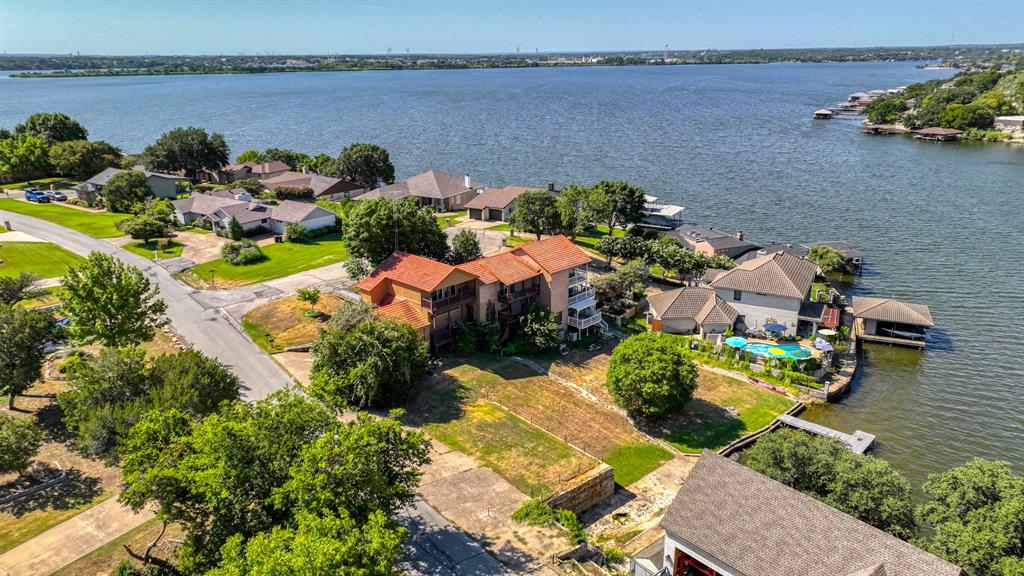 Lake living without all the upkeep! This waterfront corner-unit condo in DeCordova Bend Estates offers an easy, low-maintenance way to enjoy life on the lake. Owners in this three-unit building share access to a waterfront lawn area with a fire pit and dock, making it easy to relax by the water or head out for a day on the lake. Inside, you’ll find two spacious bedrooms, a generous living area, attached garage and balcony for enjoying the peaceful surroundings. The clubhouse, pool, restaurant and bar are just steps away, putting some of DeCordova’s best amenities right outside your door. Community membership also includes access to two golf courses, pickleball and tennis courts, swimming, playgrounds and more. Whether you’re looking for a full-time home or an easy weekend escape, this condo offers a great combination of waterfront living, community amenities and low-maintenance convenience.
