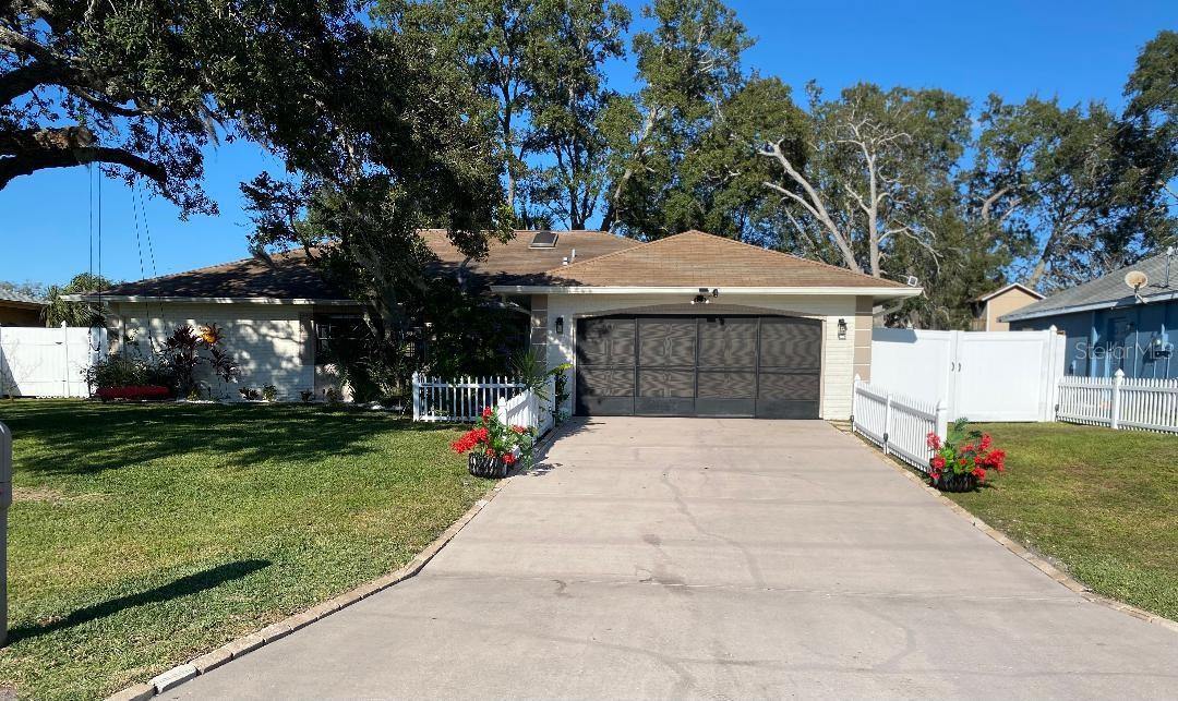 It just feels like home. Light and bright and set on a beautifully landscaped lot that includes banana trees, an avocado tree and a fig tree in the backyard. Home is located in a quiet and highly desired neighborhood with no home across the street. Large rooms have new crown moldings, new six panel doors with oil rubbed bronze handles and hardware. All new light fixtures and ceiling fans. Updated Kitchen and Bathrooms. Stainless steel appliances (Bosch and LG.) Soft close drawers and cabinets. Separate Living Room, Dining Room and Family Room. Inside Laundry Room. Split Bedroom floorplan. Two sets of patio doors go out to large, screened in Lanai with removable plexiglass windows that overlooks a privacy fenced backyard. Two sets of access gates to backyard. Large Shed has electric and outside water. Large 2 Car Garage with Screens. Sprinkler System, ADT Security System. No HOA or Flood Zone. Close proximity to shopping, medical, 3 hospitals and beaches. Short drive to Tampa and Orlando Theme Parks. Property is documented unrepaired sinkhole by the previous seller, although current sellers have had no issues whatsoever Thank you for your interest, this is a fabulous home.