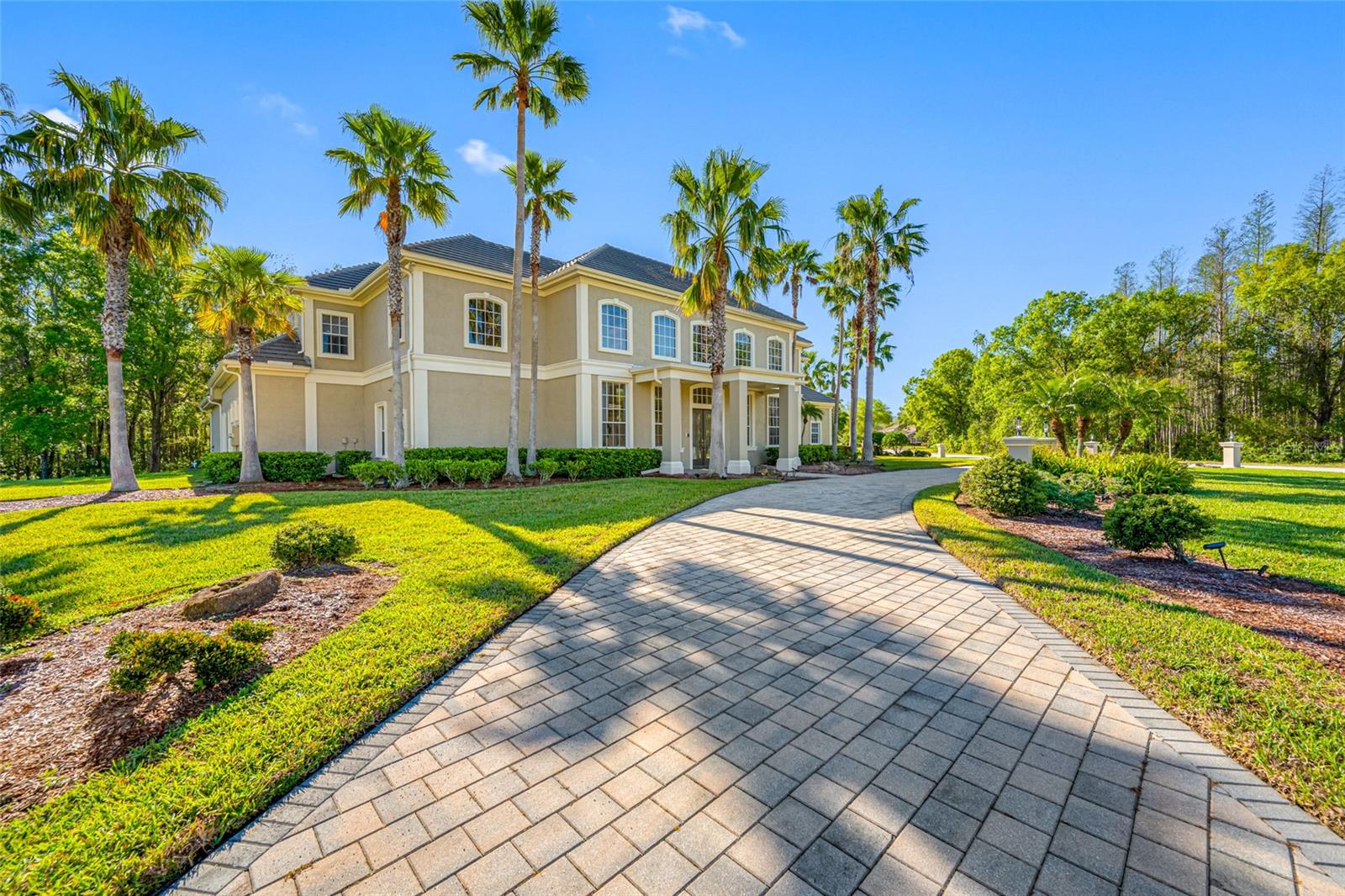 Welcome to Cour Estates located in prestigious Cheval. On this quiet, tucked away culdesac, you'll find an impressive estate on the largest lot of only 8 exclusive homes. Amongst the sprawling front lawn on your double lot, your guests can park in the generous circular driveway. Inside, you'll be captivated by the most breath-taking great room you have ever seen; complete with dramatic lighting, 30 ft. ceilings, a Juliet balcony, and flanked by two staircases on either side. Nestled behind the left staircase you will find the entrance to the owner's suite, complete with private foyer, owner's study, oversized master bath, walk-in closet, massive bedroom, separate sitting area with wet bar and pool access. Behind the right side staircase, you will find the entryway to the kitchen, wet bar, wine cellar, family room, and casual dining area as well as access to one of the guest quarters and laundry room. The guest bath has an exterior door, conveniently serving the pool area. Upstairs you will find 3 additional guest rooms, 2 additional guest bathrooms, a large cinema room, and a large balcony overlooking the private pool area. The outdoor oasis features a beautiful inground pool, spa, outdoor kitchen, and generous amounts of covered space for seating. Due to the size of the lot, you would never know you had any neighbors! No rear neighbors and a conservation view makes this home ideal for privacy and entertaining alike. If you have been looking for a one-of-a-kind home, this one's for you. Here's your chance to own the finest home in Cheval West. Call for your private showing.