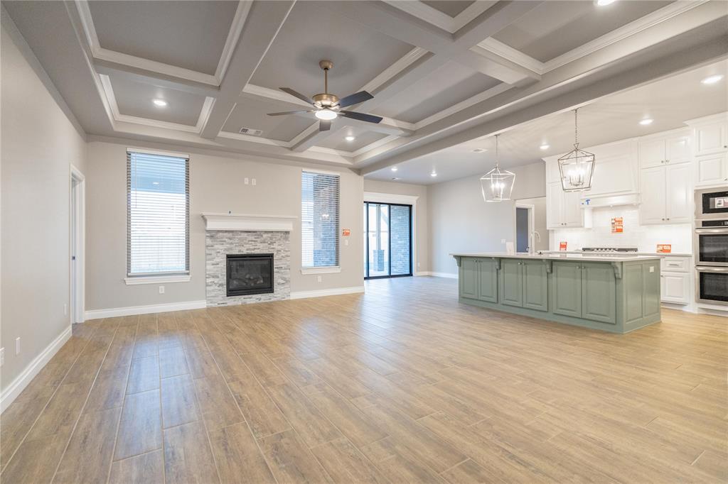 FENCING AND BLINDS INCLUDED! This Poppey Bonus Room 5 Bedroom floor plan includes 3,700 Sqft of total living space, which includes 3,350 Sqft of indoor living and 350 Sqft of outdoor living. This home offers 5 bedrooms, 3 full baths, a powder room, a bonus room, a study, a utility room featuring a utility sink, 2 dining areas, and a 3-car garage with an in-ground storm shelter installed. The great room presents a breathtaking coffered ceiling with crown molding and a ceiling fan, wood-look tile, large windows, rocker switches and eggshell paint throughout, and Cat6 wiring. The high-end kitchen supports 3 CM countertops, well-crafted cabinets to the ceiling with under cabinet lighting and cabinet hardware installed throughout, stainless steel appliances, a 5-burner cooktop, double ovens, a center island with a trash can pullout, gleaming tile backsplash, a separate corner pantry, and stunning pendant lighting. We also included a 3-panel sliding door with a 4’ back patio extension at the breakfast nook. The primary suite boasts a sloped ceiling with a fan, windows, Cat6 wiring, and our cozy carpet finish. The spa-like primary bath features separate vanities with framed mirrors, 3 CM countertops, a private water closet, a free-standing tub, a European walk-in shower, modern tile flooring, and a HUGE walk-in closet. Secondary bedrooms feature ceiling fans, windows, sizeable closets, and carpeted flooring. The covered outdoor living area includes a wood-burning fireplace, a TV hook up, and a gas line. Other amenities include our healthy home technology, a tankless water heater, a whole home air filtration system, R-44 insulation, and so much more.