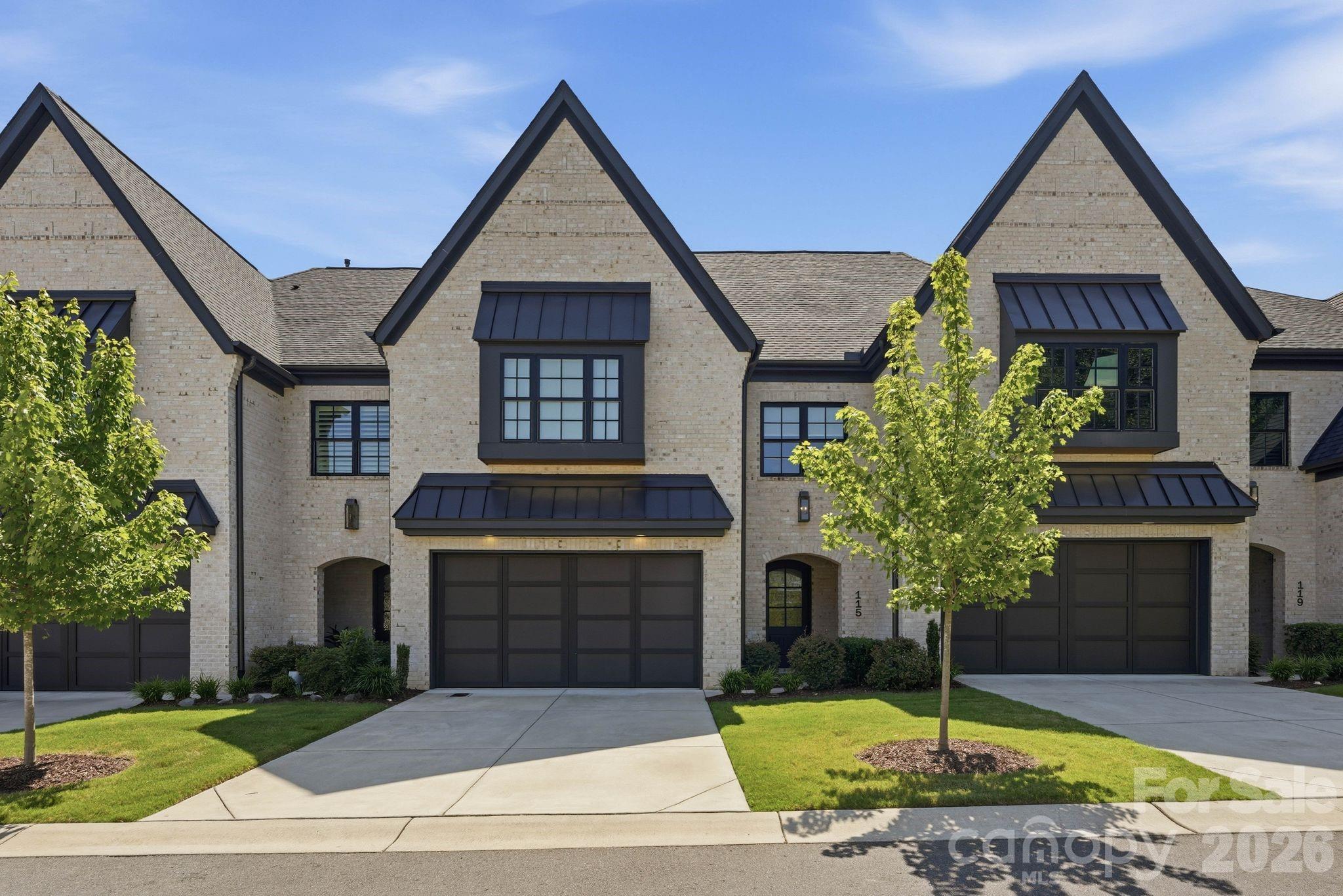 Welcome to 115 Thorncote Place, a stunning two-story townhome built in 2021by Arcadia in the highly desirable Sutton Hall community, ideally located near Olde Providence with easy access to everything SouthPark has to offer. A spacious foyer with tall ceilings welcomes you into the beautiful family room featuring a stone surrounded gas fireplace, custom built-in shelving and cabinetry, and an open-concept layout. The chef's kitchen is appointed with high-end appliances, a large marble island, appliance nook, wine refrigerator, and a gas range with four burners and a griddle. The bright dining area overlooks the fenced backyard, while custom motorized blinds in both the family and dining rooms provide added comfort and privacy. Step outside to the covered bluestone porch and fenced backyard, perfect for relaxing or entertaining, with gated access to the street. The main level also offers a generous laundry room with sink, convenient drop zone off the attached garage, pantry, and abundant storage with three additional closets. Upstairs, a wide hallway leads to the expansive primary suite featuring an oversized custom walk-in closet and a luxurious bath with dual vanities and a walk-in shower with two built-in benches. Two additional bedrooms each include en-suite baths, and a versatile flex space with rubber gym flooring provides the perfect area for fitness, office, or play. Additional hallway storage completes this exceptional home.