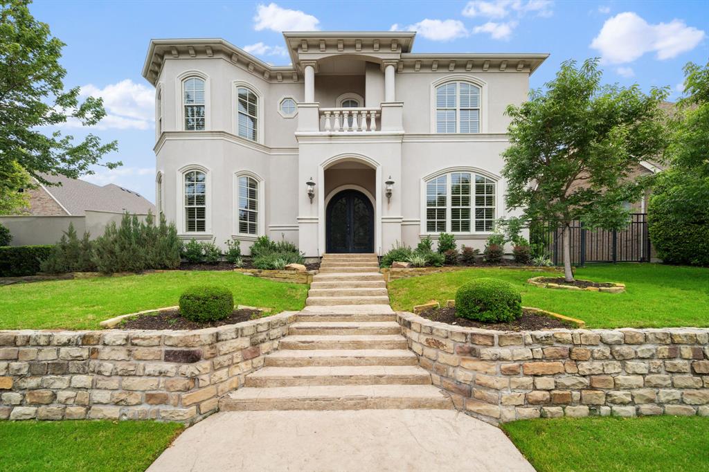 Nestled on a private cul-de-sac inside the gated Chase at Stonebriar and just across from Stonebriar Country Club, this custom Modern Venetian Villa by Pavlis Homes blends timeless European-inspired architecture with modern sophistication. Commanding curb appeal and double iron doors introduce a dramatic foyer and a light-filled living room with a soaring two-story ceiling, elegant fireplace, and views to the backyard oasis. Travertine floors sweep through the main living, dining, and kitchen areas, while a sweeping staircase with iron spindles and hardwood treads provides a striking centerpiece. Off the foyer, a handsome study with hardwoods and built-in bookcases offers a quiet work or reading retreat. The sunlit formal dining room with plantation shutters and a tray ceiling connects seamlessly to the kitchen through an impressive butler’s pantry and bar with sink and wine fridge.Designed for entertaining, the gourmet kitchen showcases top-tier stainless steel appliances—including a built-in refrigerator, gas cooktop, and double ovens—light-stained cabinetry with glass fronts, upgraded granite countertops, and a large island with sink that opens to the casual dining area and two-story living room. The luxurious primary retreat is conveniently located on the main level with direct access to the pool and spa, and an expansive walk-in closet.Upstairs, a spacious game room is paired with a dedicated home theatre and a guest half bath, while two split bedrooms each enjoy their own ensuite bathrooms. Outdoors, a lagoon-style cocktail pool and raised spa are complemented by flagstone decking, a covered patio with grill, and lush, low-maintenance landscaping. Additional highlights include modern light fixtures, custom crown molding, soft white paint tones throughout, and a full three-car rear-entry garage. The HOA maintains the front yards for an effortless lock-and-leave lifestyle. Zoned to acclaimed Frisco ISD schools.