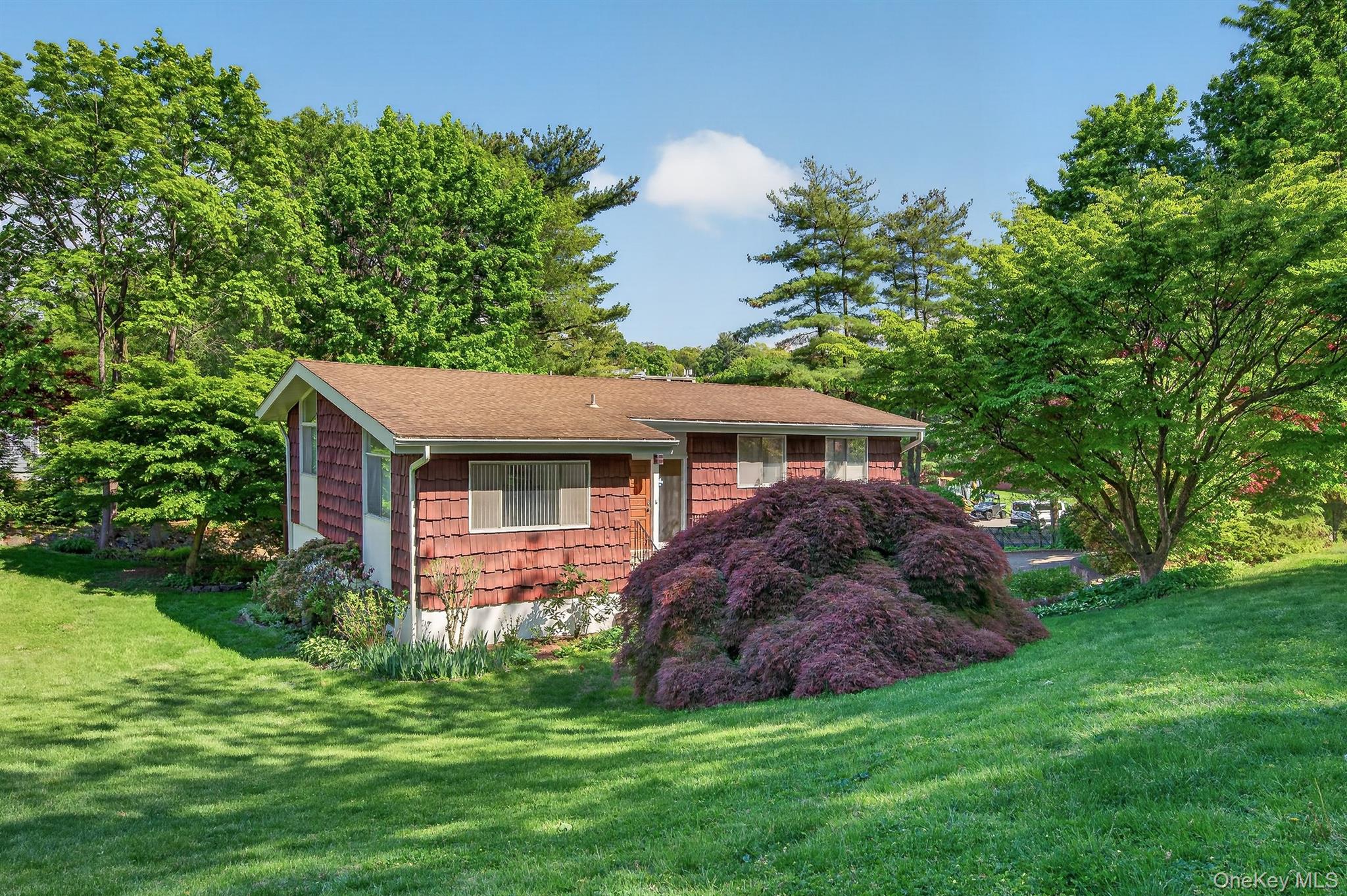 Welcome to 4 Brookdell Drive, Hartsdale, NY 10530, a spacious raised ranch-style single-family home built in the 1970s, offering endless potential in an unbeatable Westchester location.This home features 3 bedrooms, including a primary suite with its own private bathroom. The main level offers an eat-in kitchen with direct access to a deck overlooking your beautiful backyard, perfect for entertaining or relaxing outdoors. You’ll also find a full dining room and a bright living room with high vaulted ceilings, creating an open and airy feel throughout the space. Hardwood floors run throughout the main level.The lower level offers even more living space, including a large den with sliding doors leading out to a spacious patio, a recreation room, laundry room, and an attached 2-car garage.Conveniently located near shopping, restaurants, parks, and mass transit, this home sits perfectly between the White Plains and Hartsdale train stations and offers easy access to I-287, the Sprain Brook Parkway, and the Bronx River Parkway. All of this while being less than an hour from Midtown Manhattan.If you’ve been searching for a home with great bones, generous space, and the opportunity to customize it to your own style and vision, this is the one you’ve been waiting for. Come take a look at everything 4 Brookdell Drive has to offer!