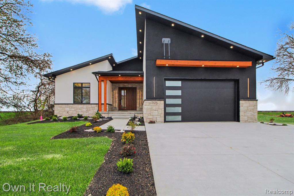 Welcome to this custom-built luxury lakeside ranch offering 3 bedrooms, 2 full bathrooms, and breathtaking, unobstructed views of Lake Erie from nearly every angle. Designed with a modern, elevated aesthetic, this home blends clean architectural lines with warm, natural finishes to create a true resort-style living experience...From the moment you enter through the statement pivot door, you're greeted by an expansive open-concept layout flooded with natural light. The seamless flow between the living, dining, and kitchen areas is anchored by engineered hardwood flooring, porcelain slab accents, and a sleek fireplace with a frameless TV - creating a space that is both sophisticated and inviting....The designer kitchen is equipped with stainless steel appliances, custom finishes, and an effortless connection to the main living space - perfect for entertaining or everyday luxury....Additional Second Kitchen...Both bathrooms and the laundry room feature heated floors, adding a level of comfort that elevates daily living. Throughout the home, cedar finishes inside and out provide warmth and character, while Andersen 400 windows frame the stunning lake views and bring the outdoors in....Step outside to a backyard that feels endless—lush green space leading directly to the shoreline of Lake Erie. Whether you're hosting, relaxing, or planning to add a dock, this setting offers year-round enjoyment and unmatched tranquility...Additional features include: Smart home system with integrated switches....Interior & exterior audio system...Full camera/security system...Backup generator...Soffit lighting for a dramatic exterior ambiance...Fully Finished Heated Garage...Turn-key, thoughtfully designed, and positioned on one of the most desirable waterfront settings—this home offers a rare opportunity to own a modern luxury retreat on Lake Erie!