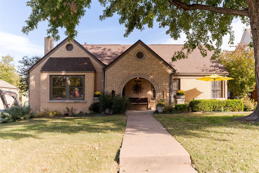 Located on a quiet, no-through street one block from the park, this 1935 blonde-brick Tudor sits on a corner lot in the Shepherd Historic District. Twin front gables, round brick vents, a rowlock brick arch, and a wrought-iron terrace highlight its architecture. Inside, original oak floors, stained woodwork, coved ceilings, and built-in cabinetry retain its historic character. The living room features a vaulted, coved ceiling, deep-silled windows, and a fireplace with mosaic tile surround and stained wood mantel. Arched built-in bookcases frame the opening to the dining room, where original crown molding and a pass-through connect to the kitchen. Remodeled 2021, the kitchen features custom cabinetry, quartz countertops, glass subway tile backsplash, stainless steel appliances, and pantry storage. An adjoining breakfast nook retains its original arched corner cabinets. Three bedrooms offer flexibility. The large primary bedroom features a walk-in closet, while the second bedroom includes a private half bath. A third bedroom overlooking the front terrace could serve as an office or den. The hall retains its original built-in desk and linen storage, along with a dedicated laundry area. The remodeled hall bathroom features subway tile, marble mosaic flooring, walnut vanity, and medicine cabinet. Outside, a spacious fenced backyard offers a large concrete patio with cafe lighting and room for entertaining. Significant improvements include electrical panel, kitchen and bathroom rewiring, PEX water supply lines, PVC sewer line, HVAC replacement, and added crawl space supports. Additional work includes a 2016 Class 4 impact-resistant roof, gutters, attic insulation, extensive brick repointing, restoration of the front porch and facade, wood window reglazing and storm windows. Minutes from the Plaza District, Midtown, I-44, and beyond, this 1935 Tudor offers historic character, substantial improvements, and convenient access to Oklahoma City's popular destinations.