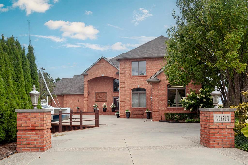 Exceptional lakefront home on a private peninsula. Dockage for two 80' boats, plus 4 smaller boats with boat lift. Over 200' of seawall. Spectacular custom built newer home. 4 huge bedrooms featuring 2 primary suites, one on the 1st floor and the other on 2nd level with custom closets. 1st floor primary has master with French doors to patio and 9' circular in-ground hot tub. 2nd floor suite features fireplace, sitting area and balcony overlooking the lake. 2 story great room with floor to ceiling windows, two-way split rock fireplace, library with hardwood floors. Gourmet kitchen with quartz counters leading to large screened porch. Whole house generator and central vacuum. Heated 3 car attached garage with separate 4th bay workshop. Gorgeous property. A one of a kind residence.