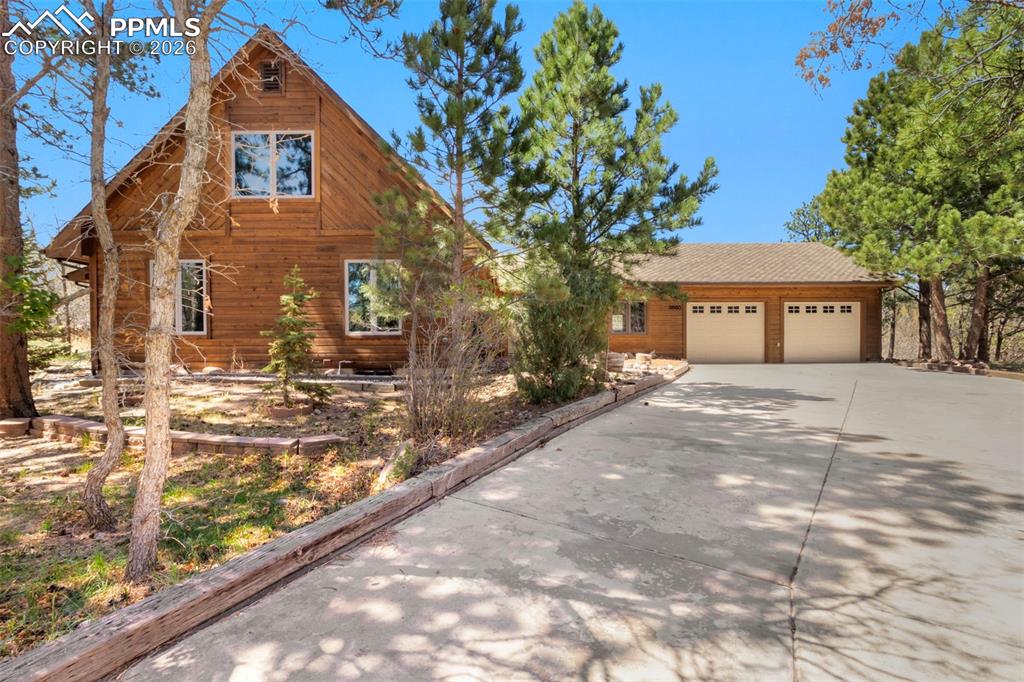 Don’t miss this beautiful home nestled among the trees on a one-acre lot, offering exceptional privacy and a peaceful, natural setting. Enjoy scenic views from every window, creating a true connection to the outdoors. The home features convenient main-level living with a highly functional and comfortable floor plan. The interior has just been freshly painted, and new carpet has been installed on the main and lower levels, giving the home a clean feel. The updated kitchen is equipped with granite counters and stainless steel appliances, while the dining area is designed for ease of use and everyday living. The formal living room is warm and inviting, showcasing a gas fireplace, stunning wood beams, and large windows that fill the space with natural light and frame the surrounding landscape. A spacious sunroom provides the perfect spot for relaxing or indoor gardening. The main level primary bedroom offers a private bath, a large walk-in closet, beautiful wood beams, and plenty of windows to take in the surrounding beauty. The main level also features a flex room ideal for a home office or gym, a convenient stackable laundry area, and a powder bath. Upstairs, you’ll find two generously sized bedrooms and a full bathroom. The basement expands the living area with a large family room featuring a cozy wood-burning stove, perfect for relaxing or entertaining. It also includes a large bedroom with an oversized walk-in closet, a ¾ bath, a substantial workshop ideal for hobbies or projects, and a large utility room with additional laundry hookups. Additional highlights include a 2.5-car oversized garage with a dedicated workbench area, offering ample space for storage/projects.  Newer vinyl windows, boiler, water heater & exterior stain. Step outside to the covered deck and take in the beauty of the serene surroundings. The property offers a true sense of tranquility, with frequent visits from deer and other wildlife, making it a perfect retreat to unwind and enjoy nature.