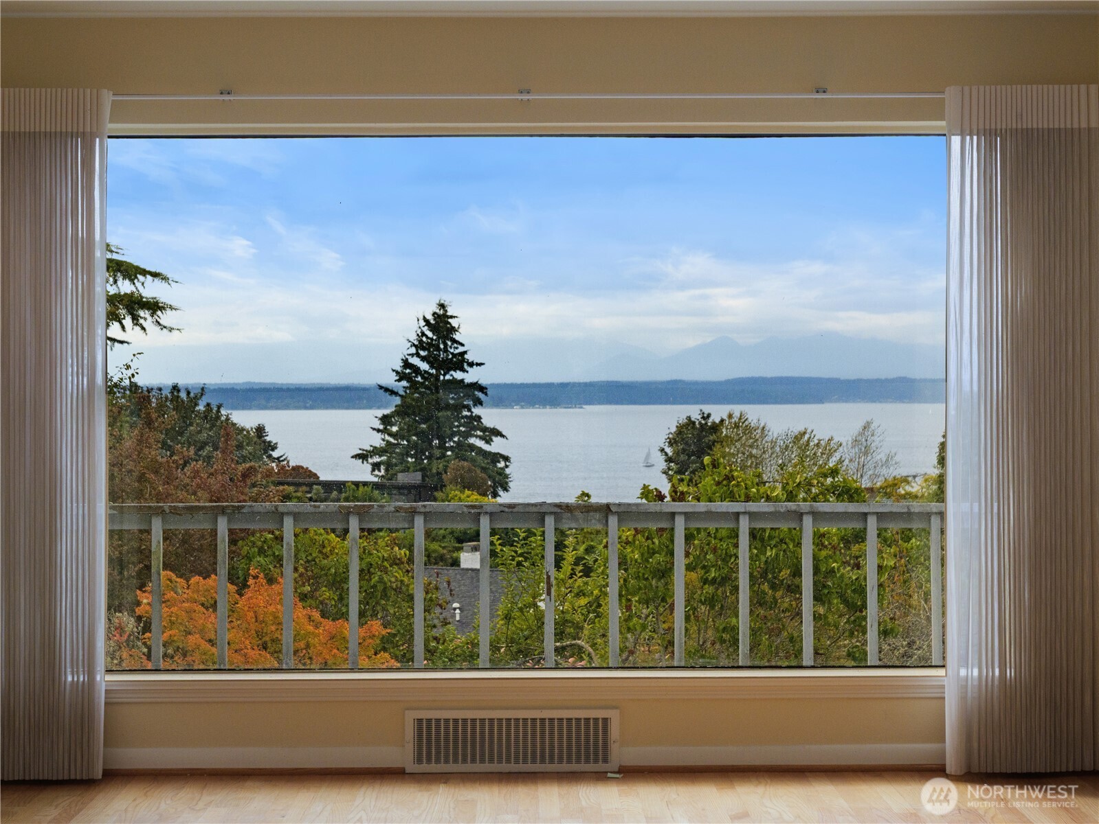 Calling all builders, visionaries, and renovation specialists! Opportunity knocks in Blue Ridge, one of Seattle's most sought after view communities. This 4 bedroom, 2.5 bath fixer upper offers great bones and endless potential. Enjoy sweeping views of Puget Sound and the Olympic Mountain Range from nearly every space. The main level features soaring ceilings in the ensuite primary suite, a dedicated office/library, a spacious deck framing the water and mountain views, and a kitchen with built in desks overlooking the Sound. The lower level is a full ADU with two bedrooms and a three quarter bath, ideal for multigenerational living, guests, or rental income potential. An attached garage, generous storage, and gracious front and back yards complete the offering. Homes in Blue Ridge rarely trade, and one with this layout, square footage, and panoramic views is a rare find. Bring your contractor and your vision!
