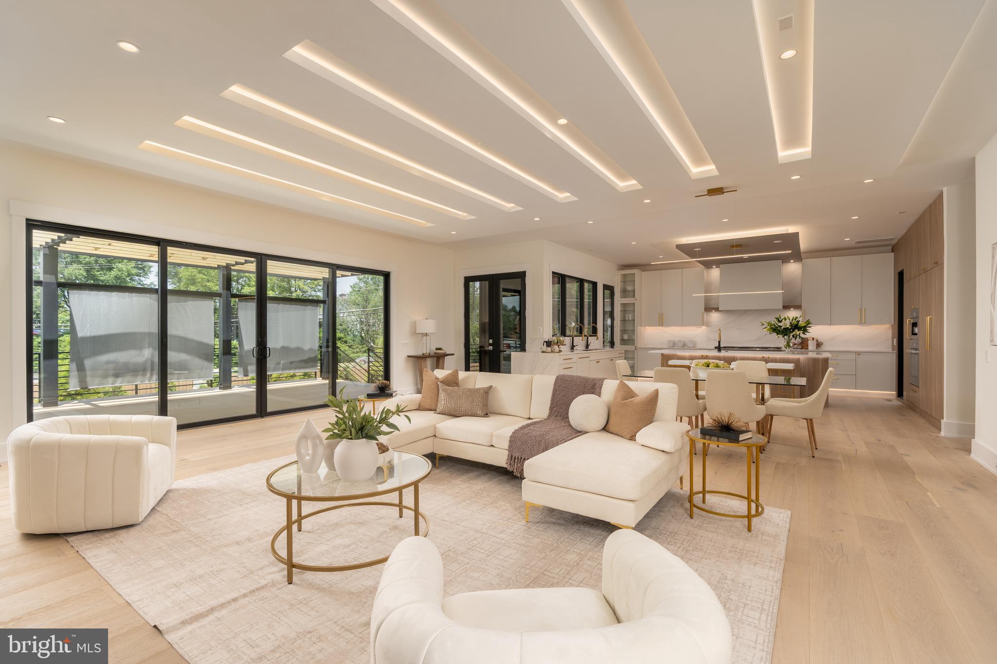 Experience elevated living in this luxury new construction architectural gem—where thoughtful design, luxury finishes, and a prime location just steps from Westwood Country Club come together seamlessly. Designed with entertaining in mind, this home offers the perfect setting for hosting everything from large celebrations to intimate gatherings with ease and elegance.A dramatic two-story foyer welcomes you into over 7,450 square feet of artfully crafted living space featuring 7 bedrooms and 6.5 bathrooms. The open floor plan flows effortlessly through formal and informal living areas, highlighted by 10-foot ceilings, expansive picture windows, and warm wide-plank hardwood floors throughout the main level. The chef’s kitchen is a true showstopper—complete with a 9-foot center island. For easy everyday living there is a supplemental culinary food prep with a large sink, serving counter, built-in cabinetry and a second dishwasher. Miele appliances, a 60-inch side by side refrigerator, a built-in plumbed coffee station, and a separate butler’s pantry, all beautifully designed for everyday living and effortless entertaining.The family room features a sleek ceiling design with integrated tape lighting, a linear gas fireplace with passive heat flow, and a wall of windows that open to a massive deck with a trellis-style ceiling and shades—creating a seamless indoor-outdoor experience for guests. There is also a screened porch which is accessible from the kitchen, family room and the deck.  Round out the main level is a secondary suite that can be used as an office or bedroom, adding to the versatility of the home's layout. Completing the main level is a spacious three-car tandem garage equipped with two EV charging outlets.The open staircase, detailed with custom Poplar wood partitions, is a design centerpiece leading to the second level where you are greeted by a spacious informal living area. The primary suite is a luxurious retreat featuring its own heating and cooling system, two walk-in closets, a spa-inspired bath, and a private sitting room with fireplace—ideal for ideal mornings or unwinding at the end of the day.  Three additional spacious bedrooms each with its own bathroom and ample closet, and one with balcony for outdoor enjoyment.The sprawling lower level features a stunning recreation area with a wet bar and a media room. Additionally, there are two flexible rooms that can serve as bedrooms or an exercise space, along with a full bath. French doors provide access to a covered patio, ensuring privacy and comfort for guests or multigenerational living.Situated in a new, private six-home cul-de-sac with no HOA, across from the golf course —walkable to shops, Whole Foods, restaurants, and coffee spots, bike path, and minutes from Tysons Corner and Metro access. With standout design and a layout built for entertaining, this home delivers an unmatched lifestyle in one of Vienna’s most desirable locations.