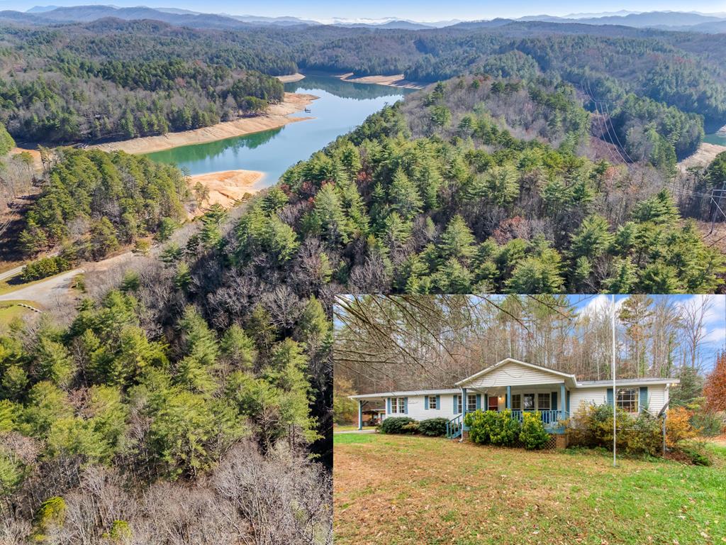 Discover peaceful mountain living on nearly 11 unrestricted acres with this inviting 3-bedroom, 2-bath manufactured home set on a brick foundation and offering the privacy and freedom you've been looking for. Tucked in a quiet, wooded setting just a stone's throw from Hiwassee Lake and bordering USFS land, this property provides endless opportunities for recreation, expansion, or simply enjoying the outdoors with no HOA to limit you. A detached garage with power and a roll-up door, plus a gravel driveway from the road to the house, add convenience and functionality. Step onto the welcoming front porch and inside to a bright living room with a bay window and vaulted ceiling. To one side, you'll find two comfortable guest bedrooms—each with a walk-in closet—and a full guest bathroom, thoughtfully separated from the Master Suite for added privacy. Across the living room, a dining room flows into the spacious kitchen, with abundant cabinets and counter space, a center island, and an adjoining breakfast area. A large Great Room offers another vaulted ceiling, a stacked-stone gas log fireplace, and sliding glass doors leading to the back porch with an attached ramp. The generous Master Suite completes the interior, featuring a walk-in closet and an ensuite bath with double vanities, a step-in shower, soaking tub, and a skylight. The nearby laundry room includes a utility sink and direct access to the back porch. Recent updates include a 2023 roof replacement and a 2025 mini-split HVAC system that services part of the home. Private, practical, and perfectly located, this property offers a rare blend of comfort and freedom in the heart of nature.