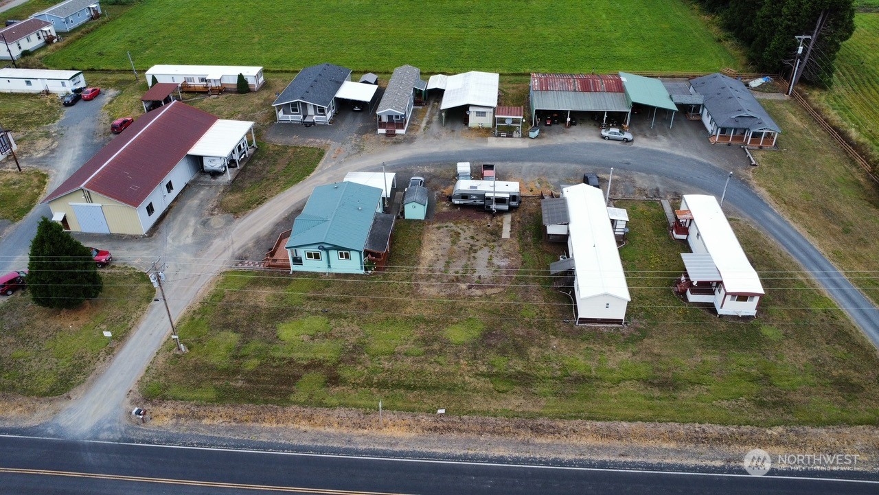 Fully operational mobile home park. On 2+/- acres, 10 units in park, 4 mobiles owned by seller, 6 spaces receive space rent. City water and sewer on 8 spaces. 2 spaces have city water and septic. Park also offers 2 shops, large in excellent condition 80x35. Could be used for dry storage, business of about anything. Zoned commercial use. Other shop has, built in floor auto lift, office space, bathroom, utility room with washer and dryer. Currently being used as a lawn mower repair shop. Most renters have been long term tenants with excellent pay history, Sell includes a Second Parcel 028526009000.  Owner Financing  available on approved credit. Terms to be negotiated.