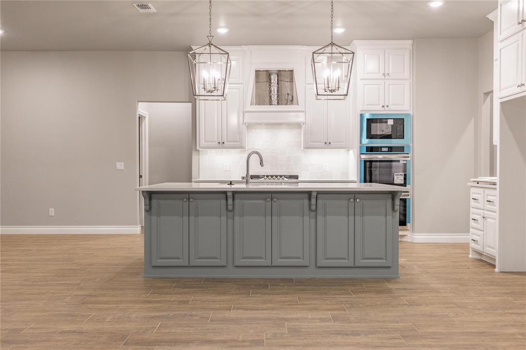 This Poppey Bonus Room 5 Bedroom floor plan includes 3,700 Sqft of total living space, which includes 3,350 Sqft of indoor living and 350 Sqft of outdoor living. This home offers 5 bedrooms, 3 full baths, a powder room, a bonus room, a study, a utility room featuring a utility sink, 2 dining areas, and a 3-car garage with an in-ground storm shelter installed. The great room presents a breathtaking coffered ceiling with crown molding and a ceiling fan, wood-look tile, large windows, rocker switches and eggshell paint throughout, and Cat6 wiring. The high-end kitchen supports 3 CM countertops, well-crafted cabinets to the ceiling with under cabinet lighting and cabinet hardware installed throughout, stainless steel appliances, a 5-burner cooktop, double ovens, a center island with a trash can pullout, gleaming tile backsplash, a separate corner pantry, and stunning pendant lighting. We also included a 3-panel sliding door with a 4’ back patio extension at the breakfast nook. The primary suite boasts a sloped ceiling with a fan, windows, Cat6 wiring, and our cozy carpet finish. The spa-like primary bath features separate vanities with framed mirrors, 3 CM countertops, a private water closet, a free-standing tub, a European walk-in shower, modern tile flooring, and a HUGE walk-in closet. Secondary bedrooms feature ceiling fans, windows, sizeable closets, and carpeted flooring. The covered outdoor living area includes a wood-burning fireplace, a TV hook up, and a gas line. Other amenities include our healthy home technology, a tankless water heater, a whole home air filtration system, R-44 insulation, and so much more.