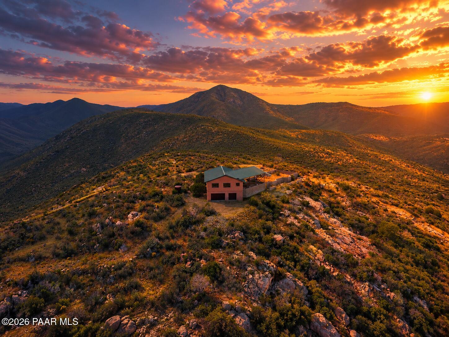 A truly unique property. Perhaps the only one of it's kind in the vicinity. 27 acres on top of a mountain with non-stop, 360 degree views. Property is being sold as vacant land. Yet, the property has 1,500sq.ft. of livable space including a six-car (6) garage and workshop. Open floor plan, kitchen, two bedrooms and a full bath, with panoramic views from every window! An additional 4,000sq.ft. of stem walls are ready for someone to finish this dream-home. (Home plans included). There is an established well and 3600 gallon water tank. Low HOA fees, gated entry, and grazing rights.A chance to own a unique property and complete a million-dollar-view vision.