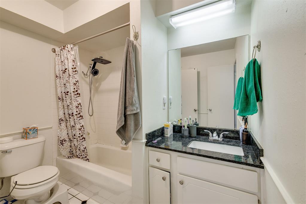 Spacious upstairs condo at 6732 N Meridian Ave, Apt D featuring a large living area with fireplace, wood-look flooring, dining space, and a kitchen with granite countertops, stainless steel appliances, gas range, dishwasher, and ample cabinetry. The oversized bedroom includes a separate flex area ideal for an office, workout space, or sitting room, plus a walk-in closet. There is also a dedicated space with hookups to accommodate a stackable washer and dryer. Additional features include ceiling fans, a full bath with granite countertop, and a private exterior entrance. Conveniently located near shopping, dining, and major roadways. Great opportunity for an owner occupant or investor.