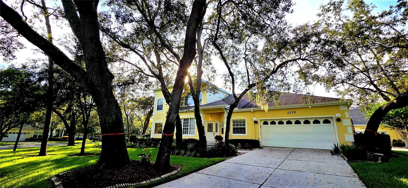 This stunning home is nestled in the gated community of Forest Retreat, located in Palm Harbor. The owner has meticulously maintained this lovely home. Step thru the stylish lead-glass entry door with sidelight that welcomes you into this lovely home with an open floorplan. The open and airy living room has high soaring ceilings, and plenty of windows, along with a cozy wood burning fireplace. The French doors leading out to the screened porch area that bathes the home in sunlight with views of open green space!  A spacious kitchen with lots of cabinets, newer appliances and a serving area with pass thru, prep area, or workstation. Off of the kitchen is the formal dining room with a built-in wet bar area. The pampering Master bedroom suite is located on the first floor that is super spacious with large mirrored, his & her closets. A double vanity with dual sinks, Jacuzzi tub, a separate walk-in shower, and a private water closet. Up the prominent wooden staircase to the second story is an open loft area that can be an office/ bonus/games room or can be converted to 3rd bedroom. Just across the hall is an oversized 2nd bedroom with an en-suite bath, large vanity and makeup counter. This bathroom has a tub / shower with doors. The laundry closet has a mud tub and front-end loader and dryer for all your cleaning needs.  A 2-car garage is attached right off the kitchen as well as a powder room. The home has meticulous gardens surrounding the home. Forest Retreat community offers a pool, hot tub, and covered pavilion area. This home is Florida living at its best! All within close proximity to the Beaches, Airports, Tarpon Springs Sponge Docks, Honeymoon Island State Park, Dunedin Causeway, highly rated schools, shopping, and restaurants.