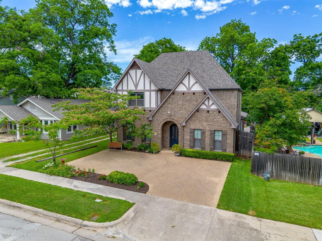 OPEN HOUSE, SUNDAY MAY 17, 1:00 pm to 2:30 pm. No Agent showings until after 2:45 PM Sunday, May 17, 2026. Located in the heart of Fort Worth’s prestigious Cultural District, this Tudor-inspired custom home blends timeless architecture with sophisticated urban living just moments from the city’s most iconic destinations, including the Will Rogers Memorial Center, Dickies Arena, Kimbell Art Museum, Modern Art Museum of Fort Worth, upscale dining, luxury wellness experiences, and the Canyon Ranch Wellness Club. Designed for both everyday comfort and elegant entertaining, the home features rich hardwood flooring, extensive custom cabinetry, multiple living areas, soaring ceilings, and an open-concept layout filled with natural light. The chef’s kitchen offers granite countertops, oversized island, wine refrigerator, stainless appliances, abundant workspace, and seamless flow into the spacious dining and living areas anchored by a striking fireplace. The primary suite is privately positioned on the main level, while additional bedrooms and flexible living space upstairs create versatility for guests, office space, or media enjoyment. Additional features include two gas tankless hot water heaters for enhanced efficiency and comfort. Outdoor living is equally impressive with a covered patio featuring a vaulted wood ceiling, outdoor fireplace, and resort-style plunge pool designed for year-round enjoyment and low-maintenance luxury. Rear-entry garage access enhances curb appeal while maintaining privacy. Combining classic architectural character with walkable proximity to Fort Worth’s premier museums, entertainment venues, equestrian events, dining, and wellness amenities, this exceptional property offers an elevated lifestyle in one of the city’s most desirable locations.