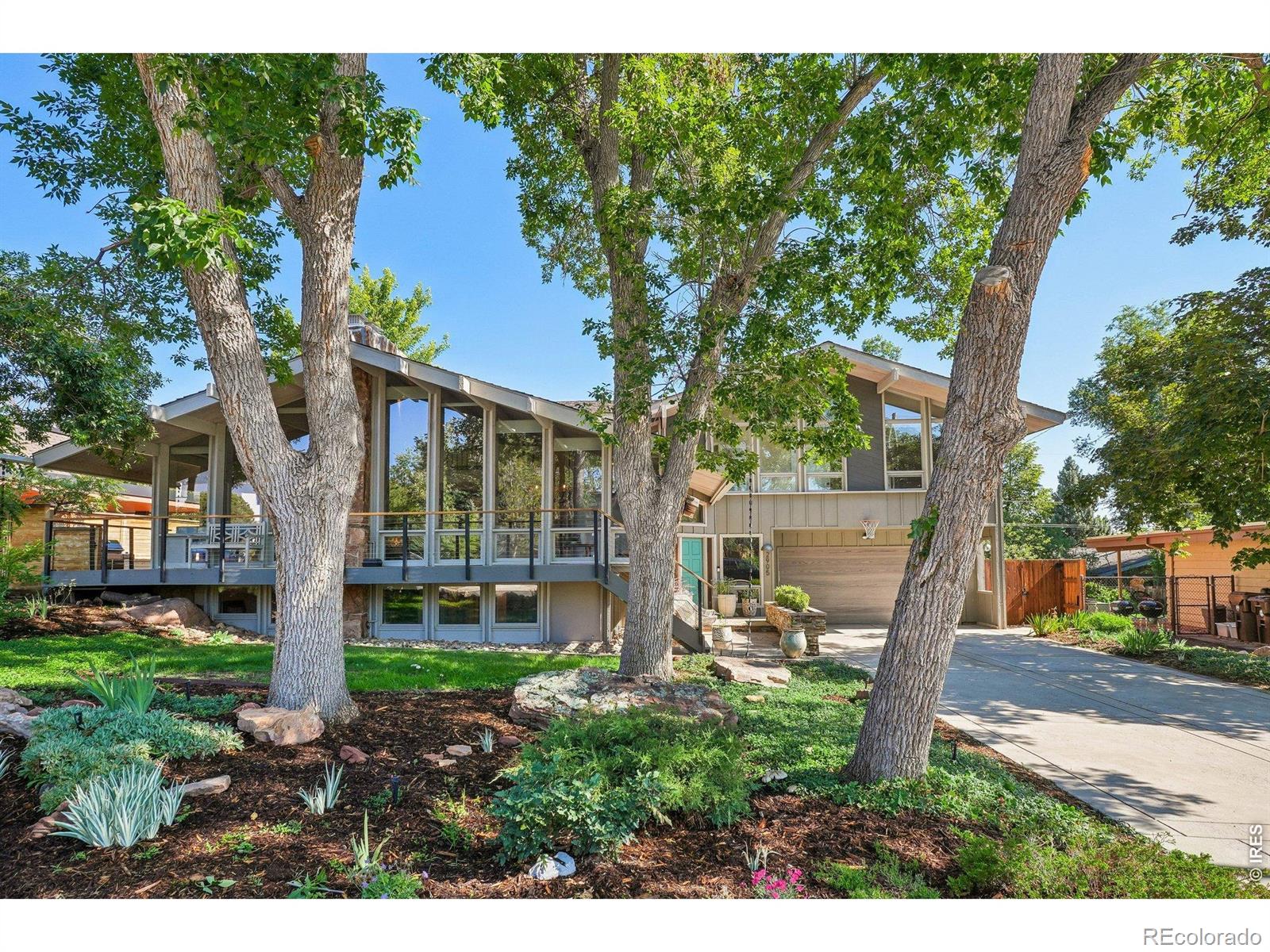 At 2905 Vassar Dr.,mid-century soul meets a modern architectural masterpiece in the heart of Table Mesa.This residence is a study in light and texture,where soaring vaulted tongue&groove wood ceilings&newly refinished oak floors create an atmosphere of organic elegance.Floor-to-ceiling windows dissolve the boundaries between the sophisticated interior&the lush canopy of mature trees,offering a lifestyle defined by a seamless indoor-outdoor flow.The main level is anchored by a magnificent stone fireplace,serving as a warm focal point for the open living spaces.In the kitchen,granite surfaces&premium finishes meet a sun-drenched breakfast nook,where south-facing mountain views provide a breathtaking backdrop for your morning coffee.Just off the kitchen,the dining room offers easy access to the backyard for effortless entertaining.This level also hosts a secluded ensuite bedroom,perfect for guests or a quiet home workspace.The entire upper level is a dedicated sanctuary.This primary suite is a true showstopper,offering sweeping mountain views that serve as a daily backdrop.Warm up by the glow of the electric fireplace before stepping into the spa-inspired bath.This indulgent space features a large soaking tub&shower enclosed by glass walls,custom vanity,dual sinks,heated floors&high-end tile.It's complemented by a massive walk-in closet that feels like a boutique dressing room,complete w/its own private balcony.The lower level provides a versatile retreat with 3 additional BDRs and a spacious secondary living area centered around its own fireplace.Outside,the wrap-around deck invites you to relax or entertain amidst the landscape.Situated w/easy access to the Skunk Canyon trail system,this home offers a direct connection to Boulder's iconic outdoor lifestyle while maintaining an air of high-end sophistication.This is more than a residence;it is a meticulously crafted environment designed for those who appreciate architectural integrity&the beauty of the natural world.