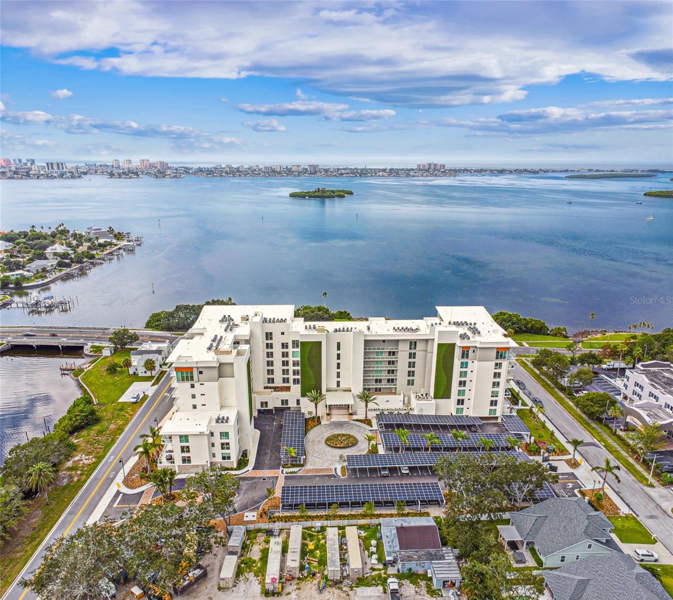 Sun-filled South facing 2 Bedroom + 2 Bathroom residence with oversized private terrace and water views at Serena by the Sea! Discover refined luxury coastal living at Serena with approx. 23,000 SF of resort-style amenities and 24-hour concierge. This convenient garden level residence is elevated above street level and offers 1,420+/- sq ft of interior space, plus an expansive 489+/- SF private terrace, with southern exposure overlooking Stevenson Creek. Enjoy watching the dolphins, manatees, and other marine life from your entertaining kitchen island, appointed with high-end stainless steel Gaggenau appliances, including a 5-burner gas cooktop, built-in oven, microwave, Bosch French door refrigerator, and dishwasher. A large waterfall quartz island anchors the space with spacious breakfast bar, paired with custom-made Italian cabinetry and additional lighting upgrades for functionality and visual appeal. Porcelain marbled tile flooring spans the entire interior living spaces and terrace. Two sliding glass doors open from the bright living room to the private terrace. The owner’s suite features a spacious bedroom with sliding glass door offering direct access to the terrace and south-facing water vistas. Its ensuite bathroom boasts a frameless glass enclosed rainfall shower and floating double vanity. The guest bedroom has floor-to-ceiling windows and is adjacent to the second full bathroom including a tub with shower. The dedicated laundry room offers hookups for washer & dryer is conveniently located next to the kitchen. Residents have access to the professionally designed resort-style amenities, including a heated saltwater pool overlooking Clearwater Bay, poolside cabanas and summer kitchens with grills, a wellness spa, sauna, fitness center, and social lounge. Serena by the Sea is a one-of-a-kind gated, boutique luxury condominium located in Clearwater, just minutes from the world-famous Clearwater Beach and Downtown Dunedin, convenient to St. Petersburg & Tampa, and less than 20 mi to Tampa International Airport. Must See!