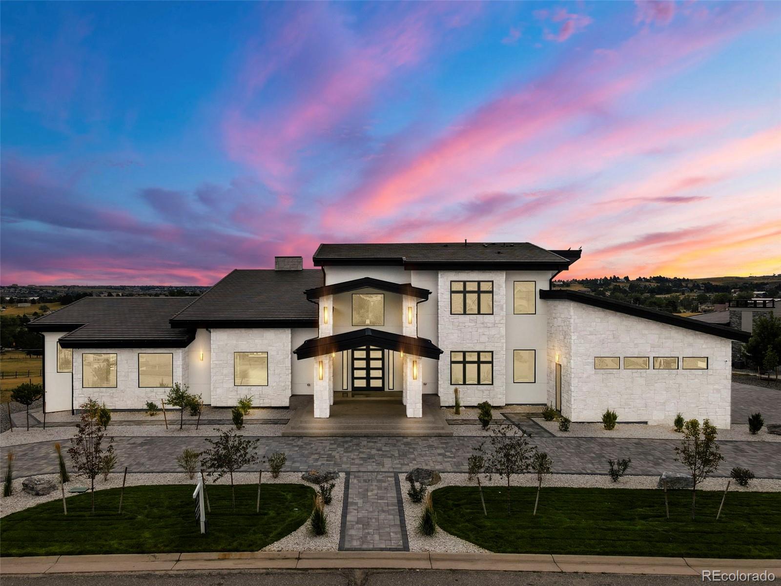 This exquisite New Construction is nestled in the prestigious Estancia neighborhood, one of Colorado’s most exclusive communities. This luxury estate offers a well-thought-out open layout and first-class amenities, all within a serene location. Within this home, you’ll find six beautiful en-suite bedrooms, each with its own private bathroom and walk-in closet. With towering ceilings, numerous windows, and elegant lighting fixtures, each room features its own unique design. The main-level master suite includes a balcony overlooking the lush sports court that makes this property stand out, as well as two private bathrooms and two separate walk-in closets.  The gourmet kitchen is outfitted with top-tier appliances, custom quartz countertops and backsplash, two large islands, and luxury pendant chandeliers.  With each level featuring its own laundry room and wet bar, this residence is like nothing you’ve ever seen before. This home is an entertainer’s dream, featuring an exercise room, expansive wine cellar, large home theater and game room, sauna, steam room, two master suites, a home office with its own private bathroom, a convenient elevator wrapped in breathtaking tile work, a five-car garage equipped with an EV charging station, and—most importantly—a colossal multi-use sports court with a fully equipped wet bar that flows seamlessly into the home’s gym. Beyond the interior of this space, you’ll find exquisite landscaping and inviting gathering areas positioned throughout the exterior of the property. This new build features over 3,800 square feet of decking, including a spectacular rooftop deck with panoramic views and a second wraparound deck that connects the walkout basement to the main floor. This one-of-a-kind estate delivers an unmatched combination of luxury, functionality, and design. Schedule a private showing today—this property is truly a host’s dream with features you won’t find anywhere else!