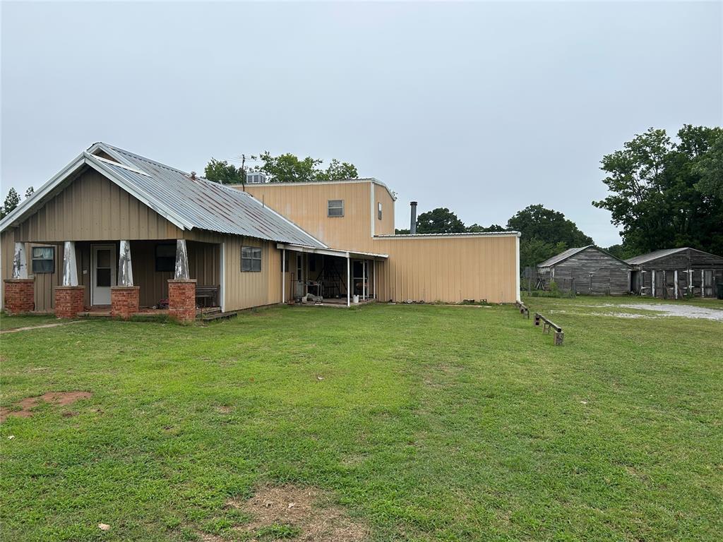 1930s farm house merged with two-story addition in 1977; two story addition contains garage, kitchen, living room, upstairs bedroom and ample storage. Beautiful acreage with large trees and linked ponds.