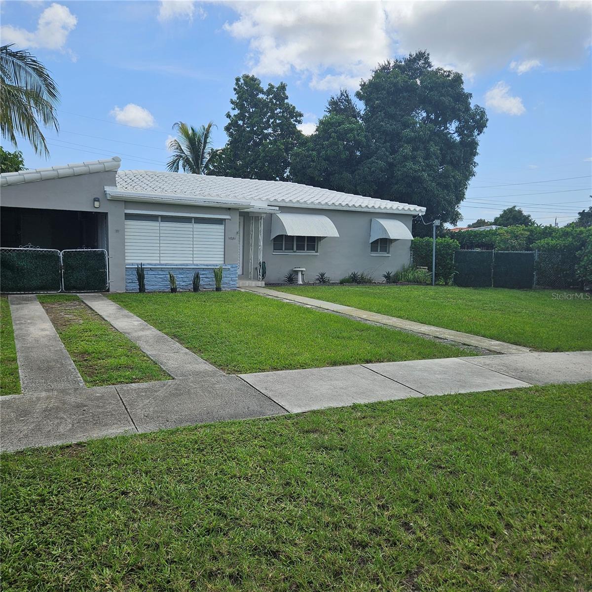 Golden opportunity to own in this fantastic close -n west Miami location!  So easy to reach downtown, Brickell, airport and expressways.  Oversized lot with mature mango tree, large side yard and quiet interior street location.  Home offers solid construction with three bedrooms and two full baths.  Baths have been updated with new tile bath surround in guest bath, new vanity and faucets.  Master bath is all new tile walls and floor, fixtures, quartz top vanity and mirror.Kitchen has new tile backsplash, faucet and counter.  There is also a very large Florida room with windows on three sides and wood beam ceiling.  There is a workshop area in the carport and also an enclosed porch in the front of the house. Full aluminum panels for the entire home along with clamshells.
