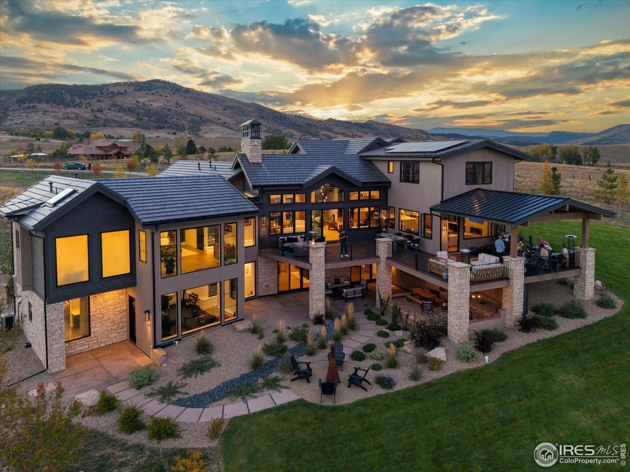 This Net Zero Sanctuary in Caribou Springs Ranch is a rare convergence of visionary design, environmental intelligence, and uncompromising luxury.Masterfully built by Stringer Construction,this 7,239sqft architectural estate is gracefully set upon 5.4 pristine acres,where privacy,serenity, and natural beauty unfold in every direction.Thoughtfully curated for elevated living,the residence has 2 main level primary suites with a total of 6 bedrooms and 7 baths,delivering both grandeur and effortless functionality.A separate 2,862sqft AUX structure,complete with its own bath,RV garage,additional 2car garage,offers exceptional flexibility for collectors and creatives,A dramatic 2 story glass corridor anchors the home,framing the surrounding landscape as living art.Expansive glass walls and floor-to-ceiling windows in the primary suite dissolve the boundary between indoors and out,immersing the home in natural light and tranquility.Designed for both wellness and performance,the estate includes a 13-foot-ceiling private fitness pavilion,seamlessly connected to a restorative spa featuring a steam shower and infrared sauna,your personal retreat for renewal.At the heart of the home,a chef's kitchen of striking scale showcases top-tier appliances and a dramatic 16-foot waterfall island, with by a discreet,fully equipped scullery for seamless entertaining.The walkout lower level transforms into an immersive entertainment retreat with an indoor-outdoor bar and a hidden speakeasy-style door into a soundproof music studio or private lounge,an experience rarely found in residential design.Located within the exclusive gated enclave of CSR, residents enjoy access to over 700 acres of protected open space,~five miles of private trails and sweeping views of the Foothills Reservoir. Amenities include a clubhouse, pool,hot tub,tennis and pickleball courts,basketball,and equestrian boarding.Just minutes from Boulder, Lyons, and Longmont, this is more than a home,it is a legacy estate.