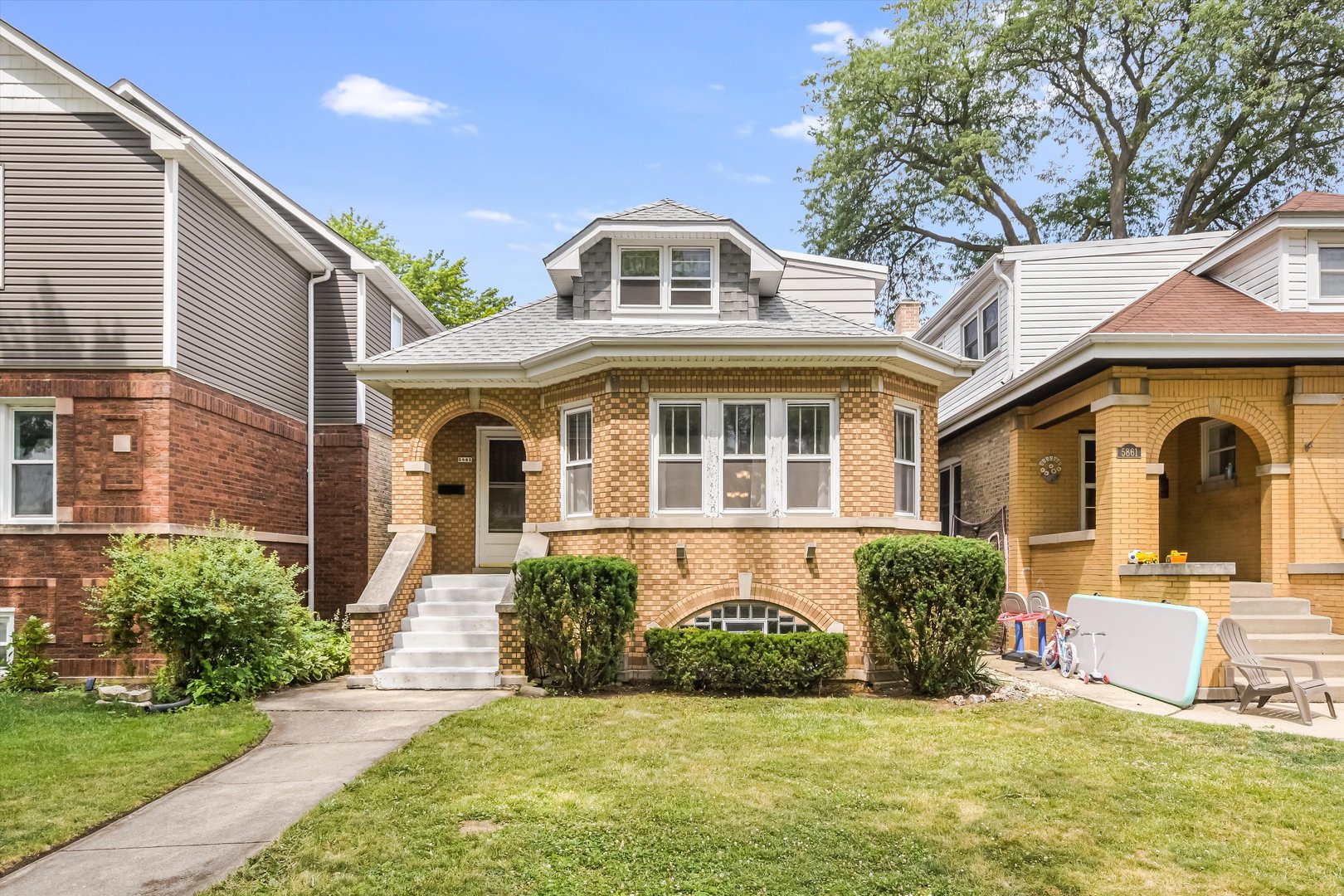 This spacious bungalow has been well maintained, preserving many of the home's wonderful original details. The exterior is highlighted by a lovely bay window and handsome blond and taupe face bricks. There is beautiful, unpainted woodwork throughout the main living spaces, generous room sizes, and storage for everything. The home opens to the foyer and original mirrored closet-door and woodwork, leading into the bright sizeable living room. The living room features an impressive decorative fireplace and mantle, more exceptional woodwork and enters to the dining room, boasting even more original details and space for entertaining. The second floor features a full bath and three large bedrooms, to compliment the two on the main floor and additional bedroom in the basement. There is a full bathroom on every floor, over 2,000 square feet of above grade space and a variety of upgrades including a new water heater and repairs to the main stack this year, tear-off roof in 2023, boiler in 2017, garage door and opener in 2018, new laminate flooring in kitchen, hallway and bedroom in 2023, etc. The front yard is smartly landscaped and the back is ready for play, gardening, or both. The basement features a second kitchen and a recreation or family room, laundry, and even more storage. The garage has enough room for your car, your mower, and plenty more. Located in the highly walkable and desirable South Edgebrook neighborhood within walking distance to the forest preserve, parks, schools, shopping, and public transportation. The home has been priced presuming the updates many buyers would want to do. This is the dream; a well-maintained home with plenty of original details revealed, lots of updates on the guts and big ticket items, and priced so the next owner(s) can afford the variety of ways to make this place their own. While it has been well-maintained and updated as described, this is an estate sale and is being sold As-Is.