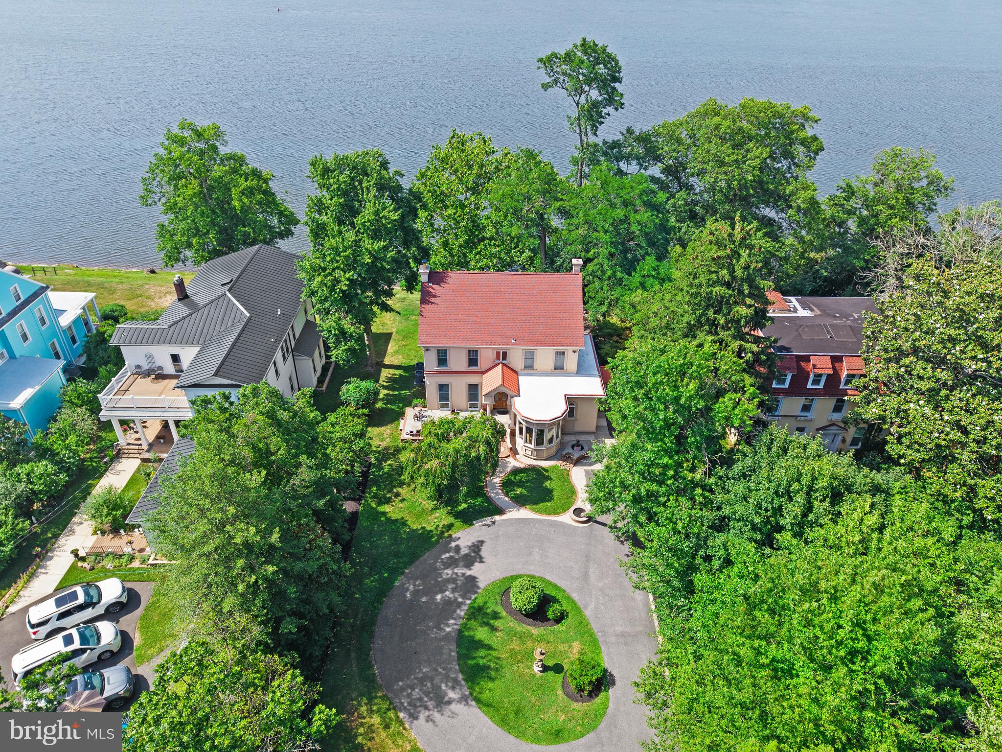 A LEGACY ALONG THE DELAWARE...Some Homes Are Built.Others Become Part Of History.Perched High Above The Storied Banks Of The Delaware River, This Extraordinary Riverfront Estate Traces Its Roots Back To 1860, When Philadelphia's Most Prominent Families Escaped The City's Summer Heat And Smog By Steamship, Building Magnificent Residences Along What Would Become One Of South Jersey's Most Treasured Waterfront Corridors.Privately Tucked Away Beyond The Original Carriage House, A Winding Drive Leads To A Graceful Circular Courtyard Where This Architectural Masterpiece Proudly Commands Breathtaking River Views. Lovingly Cared For By Only Three Owners In More Than 165 Years, Every Generation Has Thoughtfully Preserved Its Remarkable Character While Seamlessly Incorporating Modern Luxury.Step Inside And Prepare To Be Captivated.Rich Hardwood Floors With Exquisite Decorative Inlays, Soaring Ceilings, Intricate Millwork, Grand Archways And Timeless Craftsmanship Create An Atmosphere That Simply Cannot Be Replicated.The Heart Of The Home Is A Stunningly Reimagined Gourmet Kitchen Where Graceful Curves Honor The Home's Victorian Architecture. Adjacent Sits One Of The Home's Most Magical Spaces—A Spectacular Sitting Room Featuring An Extraordinary Hand-Carved Wood Ceiling Adorned With Illuminated Stained Glass And Crowned By A Dazzling Crystal Chandelier. It Is Nothing Short Of Breathtaking.Nearby, The Sun-Filled Breakfast Room Continues The Architectural Artistry With Its Elegant Circular Design, Custom Ceiling Details And Walls Of Windows That Perfectly Mirror The Home's Distinctive Exterior.The Formal Living Room Is Warm And Inviting, Anchored By A Beautiful Wood-Burning Fireplace, Exceptional Millwork And Elegant French Doors Leading To What May Be The Most Coveted Room In The Home...A Spectacular Four-Season River Room.Wrapped In Glass And Overlooking The Delaware River, This Unforgettable Space Invites Morning Coffee With The Sunrise, Quiet Afternoons Watching Sailboats Drift By, And Evenings Where The River Becomes Your Own Private Work Of Art. Across The Water, Protected Neshaminy State Park Ensures That These Peaceful, Forever-Changing Views Remain Beautifully Untouched For Generations To Come.The Formal Dining Room Continues The Elegance With Decorative Hardwood Inlays, Sparkling Crystal Lighting And French Doors That Create A Seamless Flow For Entertaining.Upstairs, The Home Offers Four Beautifully Appointed Bedrooms, Including An Elegant Primary Suite With A Beautifully Renovated Bath. A Charming Princess Suite Enjoys Its Own Private Ensuite Bath And Captivating River Views, While Two Additional Bedrooms Share A Thoughtfully Renovated Jack-And-Jill Bath.At The End Of The Hallway Awaits Another Unforgettable Surprise...A Magnificent 39-Foot Riverside Balcony Overlooking The Delaware And One Of The Property's Most Treasured Landmarks—A Majestic Pre-Civil War American Sycamore, Carefully Protected For Generations As The Riverbank Was Thoughtfully Designed Around It, Allowing This Living Piece Of History To Continue Flourishing Today.The Partially Finished Lower Level Offers Additional Living Space With Another Wood-Burning Fireplace, Creating The Perfect Retreat For Recreation, Relaxation Or Entertaining.Outside, Gently Rolling Lawns Lead Toward The River's Edge Where Nature Surrounds You In Every Direction. Every Season Brings A New Masterpiece—From Soaring Bald Eagles And Migrating Birds To Spectacular Sunsets Reflected Across The Water.This Is More Than A Remarkable Home.It Is More Than Riverfront Living.It Is A Place Where History Has Been Carefully Preserved, Beauty Has Been Lovingly Curated, And Generations Of Memories Are Waiting To Be Made.This Is Not Simply Your Dream Home.It Is A Legacy.Welcome To 122 King Street.