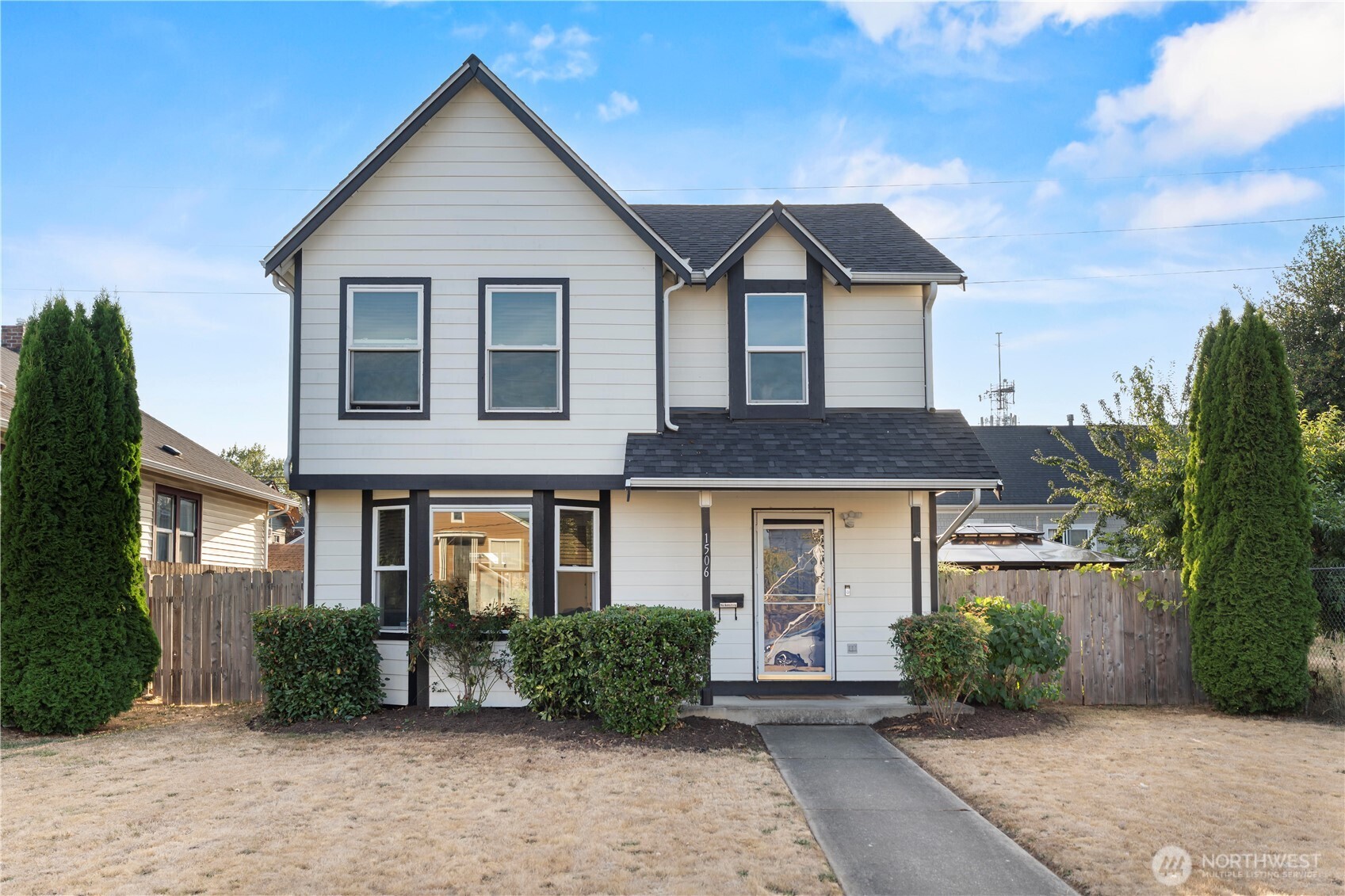 Welcome to this beautifully updated 3-bedroom, 2.5-bath home in Tacoma’s vibrant Hilltop neighborhood! Step inside to a bright, AC cooled open main level featuring updated flooring and a recently remodeled kitchen with quartz countertops, stainless steel appliances, abundant cabinetry and an oversized peninsula with bar seating, perfect for everyday living and entertaining. The spacious living and dining areas flow together nicely, creating a comfortable and functional layout.Beautifully remodeled primary bath featuring a spacious glass-enclosed tiled shower, dual-sink vanity, quartz countertops and contemporary finishes. Two additional bedrooms provide plenty of flexibility for guests, home office space or hobbies.  Outside, the fully fenced yard offers your own private outdoor escape with a covered gazebo, firepit area and plenty of room to relax or entertain. Gardeners will love the dedicated garden space and greenhouse, while two storage sheds provide excellent additional storage. Located in the heart of Hilltop with convenient access to downtown Tacoma, local restaurants and businesses, nearby parks, major medical centers and the T Line light rail connecting Hilltop with the Stadium District, downtown and Tacoma Dome Station.