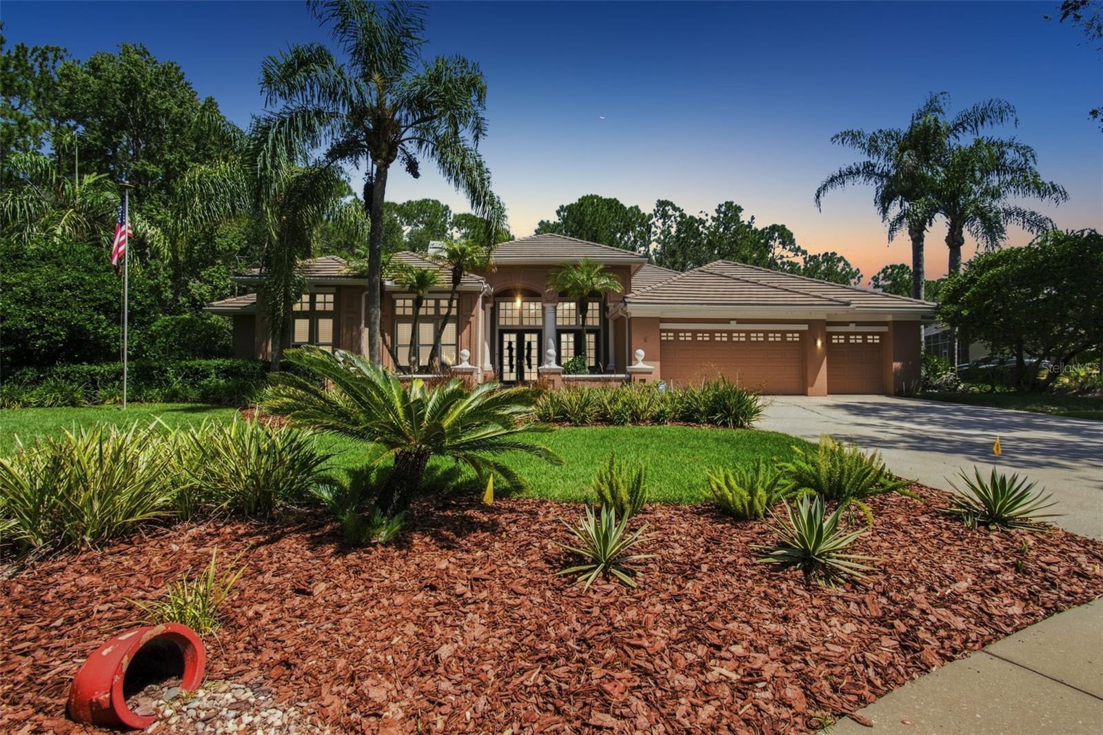 SIGNIFICANT PRICE IMPROVEMENT! LUXURY IS NOW MORE ATTAINABLE! Welcome to an exceptional private estate where elegance meets quintessential Florida living. Situated on an almost half-acre corner homesite with desirable northern exposure and serene conservation views, this expanded 4,091 SF Arthur Rutenberg Bimini VIII offers exceptional privacy in the prestigious guard-gated community of Osprey Pointe at Hunter’s Green. The floor plan features 4 bedrooms, 3.5 baths, office/den, formal living and dining rooms, and a spacious 17' x 21' family room with custom built-ins, fireplace, hardwood floors, vaulted ceilings, and abundant natural light. Dramatic pocket sliders open to spectacular outdoor living spaces.The heart of the home is a $100,000 chef’s kitchen renovation featuring custom solid-wood cabinetry, granite countertops, stone backsplash, butcher-block island, 6' x 8' walk-in pantry, and premium Wolf, GE Café, KitchenAid, and GE Monogram appliances. A central vacuum system adds everyday convenience.The expansive primary suite boasts pool and conservation views, sitting area, dual walk-in closets, spa-inspired bath, and custom boutique-style dressing room. A remarkable 21' x 27' fourth-bedroom suite with private bath, custom built-ins, and separate entrance offers flexibility for guests, multigenerational living, or a private retreat. Enjoy resort-style outdoor living in the extraordinary 41' x 50' screened lanai with conservation views, Pebble Sheen pool, French-pattern travertine decking, and summer kitchen with sink and refrigerator. Additional highlights include crown molding, plantation shutters, French doors, window seats, and a 30' x 30' 3+ car garage with 9' x 18' storage and central vacuum system, providing effortless whole-home cleaning and making everyday living easier.  Recent updates include tile roof (2019), AC (2025), water heater (2026), and upgraded bathrooms. Hunter’s Green offers a prestigious gated lifestyle with the Tom Fazio-designed championship golf course, tennis, and nearby Flatwoods trails, premier shopping, dining, I-75, and leading medical centers, including VA, BayCare, AdventHealth, and Moffitt Cancer Center. 9212 Pine Island Ct is a rare opportunity to enjoy luxury, privacy, generous living spaces, and exceptional outdoor entertaining. Discover Florida living at its finest at this newly improved price. Schedule your private showing today!