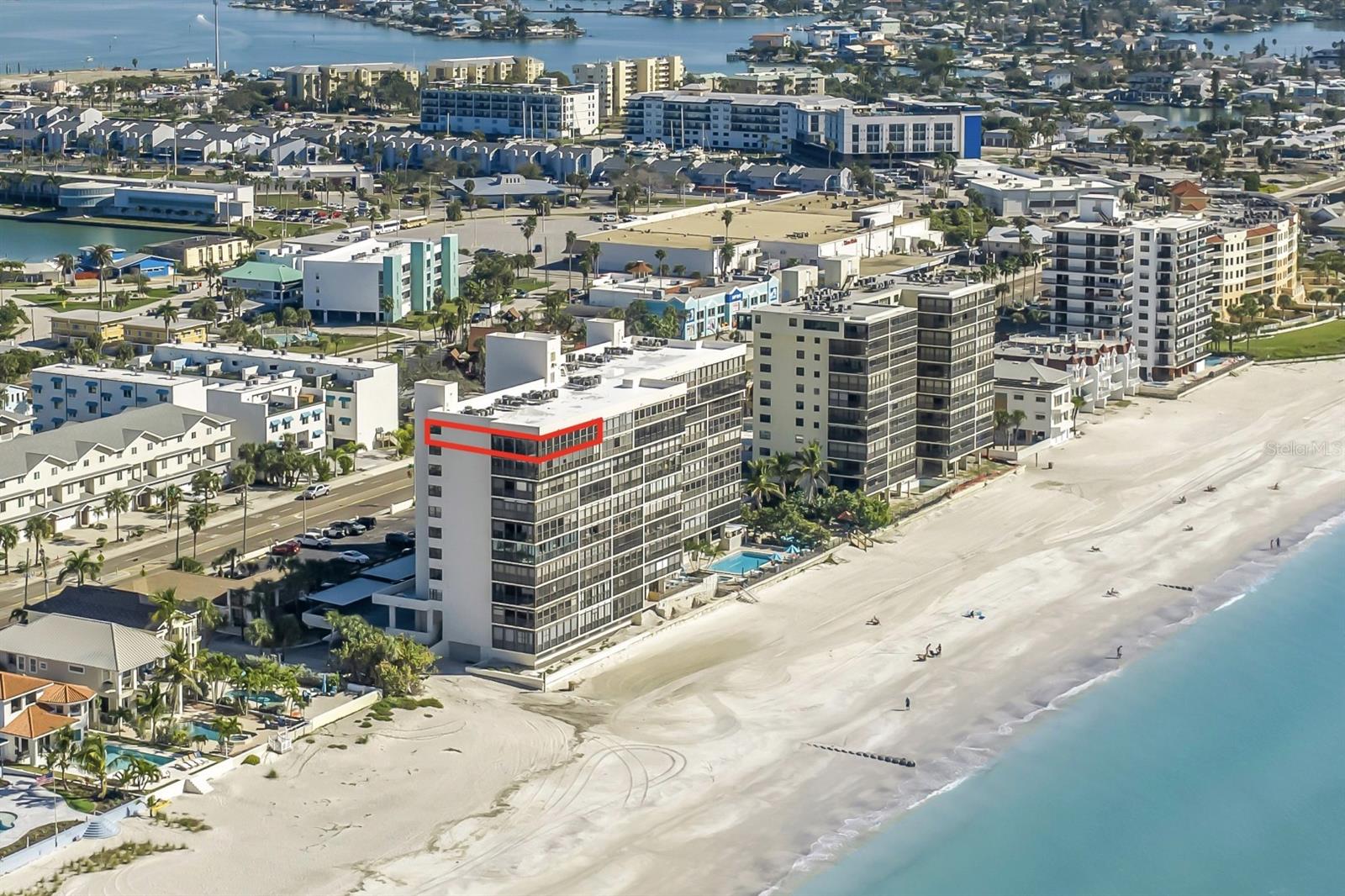 Directly overlooking the pristine white sands of Madeira Beach, this exceptional 10th-floor penthouse offers an expansive 60+ foot wraparound balcony and arguably the best view in Madeira Beach. As the final high-rise condominium for several miles along the coast, this remarkable residence enjoys unobstructed 270-degree views encompassing the Gulf of Mexico to the west, the Florida Intracoastal Waterway and the city of Madeira Beach to the east, and the picturesque shoreline stretching north as far as the eye can see. Floor-to-ceiling, impact-rated sliding doors showcase sweeping Gulf views from the kitchen, dining area, living room, and primary suite, beautifully complementing the recently completed renovation. The residence features premium finishes, high-end appliances, and carefully selected designer lighting throughout. The two guest bedrooms and luminous, window-lined laundry room offer serene Intracoastal Waterway views, ensuring every space is filled with natural light and tranquility from sunrise to sunset. Every inch of this three-bedroom, two-bath residence reflects refined design and uncompromising quality. Luxury plank flooring flows throughout, while the chef-inspired kitchen features stone countertops, premium stainless-steel appliances, and custom cabinetry. Each bedroom is outfitted with bespoke California Closets, while the primary suite offers direct balcony access and a spa-caliber en-suite bath with stone countertops and a glass-enclosed shower. The guest bath features the same elevated level of craftsmanship and finishes. Behind the scenes, extensive upgrades include all-new impact doors and windows, new plumbing and ductwork, a new HVAC system relocated for optimized comfort, a new electrical panel, updated wiring and lighting, and a new tankless water heater. The result is a seamless combination of technical excellence and sophisticated design. The thoughtful floor plan creates an exceptional sense of openness and comfort, allowing everyday living to unfold against an ever-changing backdrop of water and sky. Enjoy morning coffee on the expansive balcony, take in spectacular sunsets, or unwind in the evening as the horizon transforms in color. Here, the coastal surroundings become an integral part of everyday life. The penthouse lifestyle extends beyond the residence with a curated collection of beachfront amenities, including a heated pool and spa, inviting lounge and entertaining spaces, a beachfront fitness center, library, game room, whole-building water softener, secured lobby and under-building parking. Ideally located in Madeira Beach, this extraordinary residence is just moments from premier dining, boutique shopping, and the iconic John's Pass Village, as well as the site of a planned Autograph Collection Marriott Resort nearby. The location also offers effortless access to Clearwater Beach, Downtown St. Petersburg, world-class sporting venues, and multiple international airports. Masterfully reimagined with meticulous attention to detail and no expense spared, this distinctive penthouse presents a rare opportunity for discerning buyers seeking the pinnacle of luxury, comfort, convenience, and coastal elegance. Schedule your private showing today and experience firsthand these extraordinary views, craftsmanship, and finishes.
