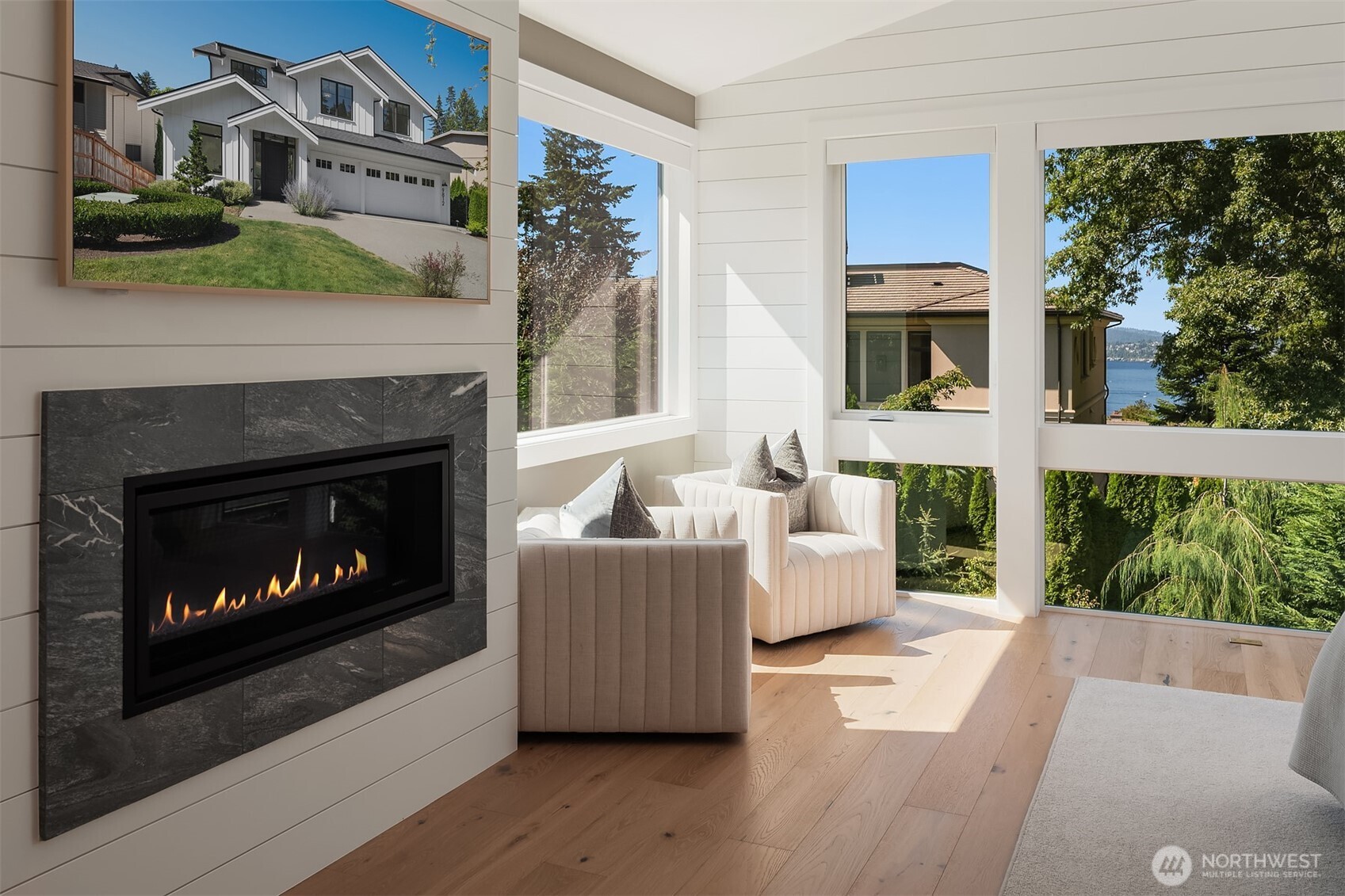 Primary bedroom sitting nook with fireplace and treetop views