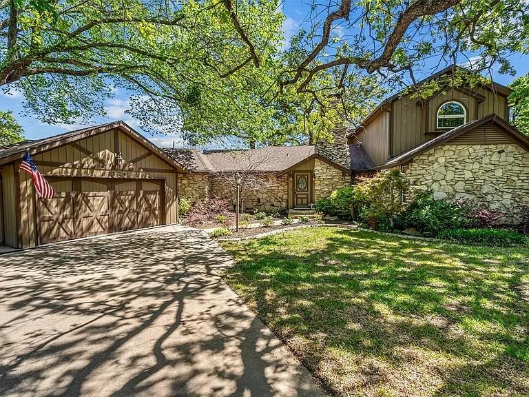 Welcome to one of the most charming homes in the highly sought-after Forest Hills Addn. Homes in this neighborhood rarely come on the market & are known for their close proximity to Lk Grapevine, nearby parks, & scenic biking & walking trails along the lake. Situated on a unique corner, peninsula-style lot, this beautiful 4br-5ba-2+ (drive through) garage home features a very private backyard surrounded by a mature tree canopy that provides abundant shade from the Texas sun, iykyk. The outdoor space feels like your own personal retreat—perfect for relaxing, entertaining, or simply enjoying the peaceful surroundings.Inside, you’ll find a flexible floor plan that offers the option for either an upstairs or downstairs primary suite. This home is full of character both inside and out—far from the typical cookie-cutter home. The family room showcases a stunning wood-burning rock fireplace that serves as a warm and inviting focal point. The kitchen has been tastefully updated and is ideal for both everyday living and entertaining, featuring a commercial-grade gas range, granite countertops, stainless steel appliances, a breakfast or buffet bar, and a generously sized dining area. Just off the garage is an incredibly versatile space that includes a full-size laundry room, a secluded half bath, and a flexible work area that could easily serve as a hobby space, mudroom, home office, or additional storage area. Upstairs offers potential for a private retreat with views of nearby Lake Grapevine—an ideal setting for a relaxing, spa-like primary suite or quiet escape. From the unique architectural details to the serene backyard setting, this home offers character, flexibility, tons of storage areas and an unbeatable location in one of the area’s most desirable neighborhoods. BUYER TO CONFIRM SCHOOLS (DOVE ELEM MAY CHANGE), ROOM SIZES ARE APPROXIMATE.