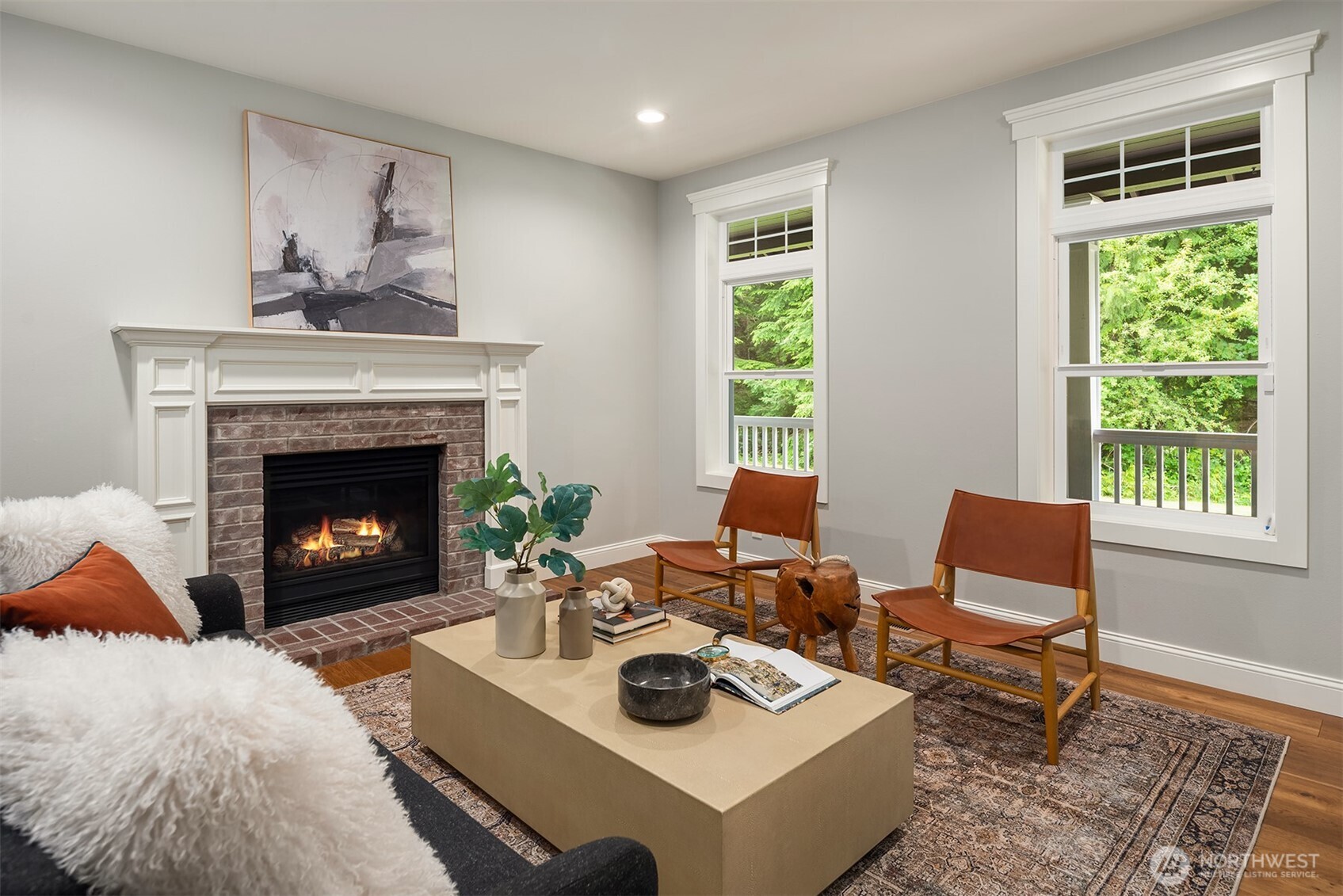 Warm and inviting family room with fireplace, large windows, and direct access to outdoor living spaces.