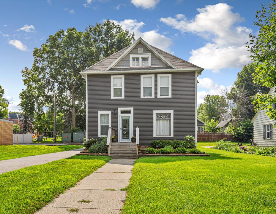 Step into this beautifully renovated 1900 home where historic character blends seamlessly. This home offers a generous layout with large, airy rooms. Stepping into the front door you'll be welcomed by a dramatic, open wooden staircase, hard wood floors and large foyer. You'll be impressed by the expansive light filled living room with wall-to-wall windows, high ceilings, neutral color palette focusing on beige and blues. The kitchen, with heated floors, is a standout with quartz countertops, a pot filling faucet, gas stove and sliding glass doors to the outdoor patio. A private dining room highlights floor to ceiling windows, modern built-in cabinets, turn of the century, architectural pocket doors and an intimate space. Also, a main level bathroom. Upstairs, the 3 bedrooms and den/office offer space to unwind. Tucked within the primary bedroom adjoins a cozy alcove perfect for a nursery, serene sitting area, or reading area. You'll find the original transitional bedroom windows- still in working order. These unique windows not only provide natural light, but also serve as a testament to the home's enduring quality and character. The upper level also homes a full bathroom with tiled and heated floors, contemporary updates combined with vintage touches, such as the claw foot tub. Also, the second level includes laundry. This home offers not only classic charm but also major updates where it counts. Recent improvements include 2020 siding and vinyl windows, 2014 Roof, 2024 water softener, 2025 appliances, 2022 furnace, high efficiency boiler, 2024 garage roof, blown insulation was added to all exterior walls and 30 inch insulation was added to the entire open attic space.