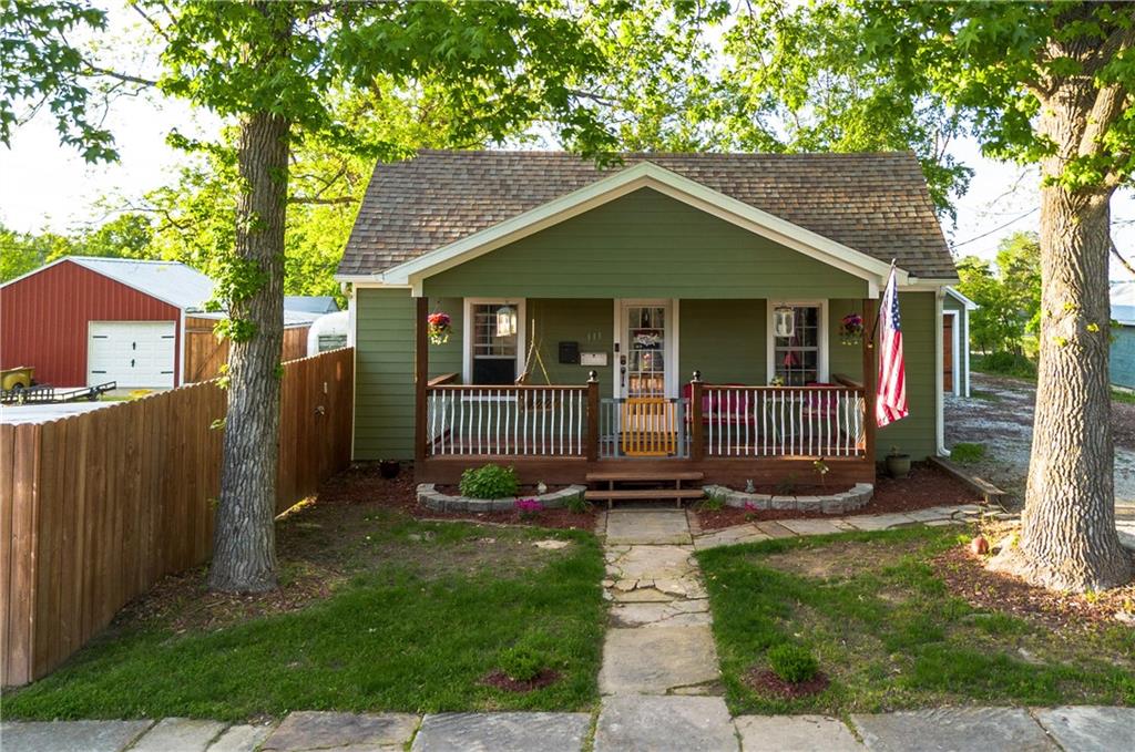 Charming Cottage Bungalow with Modern Touches & Outdoor Retreat

Welcome to your storybook home—where timeless charm meets contemporary living. This beautifully updated 4-bedroom, 2-bath cottage bungalow offers warmth, style, and incredible spaces both inside and out. The versatile layout includes a fourth bedroom currently used as a home office, easily converted to suit your needs.

The private primary suite is nestled at the back of the home, featuring a spa-like ¾ bath with a luxurious rain shower head. The kitchen is a standout with sleek modern finishes, a deep farmhouse sink, and ample cabinet space—perfect for both everyday living and entertaining.

Step outside to a backyard oasis: enjoy a stamped concrete patio with an outdoor fireplace, a covered front porch for relaxing mornings, and a spacious, privacy-fenced yard ideal for gardening, play, or gathering with friends. There's plenty of room for vehicles and hobbies with a 1-car attached garage and an additional garage space in the enclosed outbuilding.

Additional features include open covered storage, a storage shed, and a generous yard ready for your personal touch. A classic cellar basement provides space for utilities, storm shelter, and even canning.

This move-in ready gem blends comfort, flexibility, and character in one inviting package—ready to welcome you home.