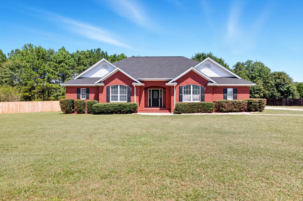 Elegant Brick Home in a Tranquil, Established Neighborhood.  Welcome to over 2,500 square feet of refined living in this beautifully maintained brick residence. Nestled in a quiet, well-established neighborhood, this spacious 4-bedroom home offers an exceptional blend of comfort, style, and functionality. Step inside to discover a bright, inviting, freshly painted interior with expansive living spaces and thoughtfully designed details throughout. The spacious kitchen features an intimate breakfast nook, abundant cabinetry, and generous counter space—perfect for everyday living or entertaining guests. The kitchen also boasts a new refrigerator.  The formal dining room, with its lovely view of the front yard, provides an elegant setting for gatherings and special occasions.  The oversized living room flows seamlessly into a sun-drenched sunroom—an ideal spot for reading, relaxing, or enjoying your morning coffee. Each of the four bedrooms offers impressive closet space, while the overall layout allows for both privacy and ease of living.  Outdoors, enjoy a large backyard framed by mature shade trees and a charming patio—perfect for hosting or simply unwinding in nature's serenity. The attached two-car garage includes ample room for storage and houses a newer water heater for added peace of mind. Flooring includes easy-care laminate throughout most of the home.  With a low annual HOA fee and unbeatable location close to town amenities, this exceptional property is truly a rare find. Recent updates include: LVP flooring, interior repaired with SW Casa Blanca, Level 3 architectural shingled roof, backyard fence w/ 2 gates, whole-house water filter, updated garage door with keypad access, new refrigerator.