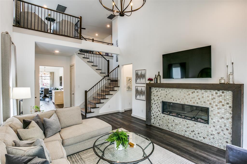 Sold fully furnished, this luxury model townhome offers the perfect combination of upscale design and low-maintenance living, ideal as a primary residence or second home. Just minutes from DFW Airport and premier golf courses, the home features soaring ceilings, expansive windows, and open living areas filled with natural light. The serene first-floor owner’s suite provides a private retreat, while the gourmet kitchen showcases custom cabinetry, premium built-in appliances, and designer finishes. Upstairs, two spacious guest bedrooms and a large game room provide versatile space for relaxation or entertaining. Energy-efficient features, including gas heating and a tankless water heater, add comfort and value. This turnkey townhome delivers a refined lock-and-leave lifestyle in a prestigious community, blending convenience, elegance, and effortless living.