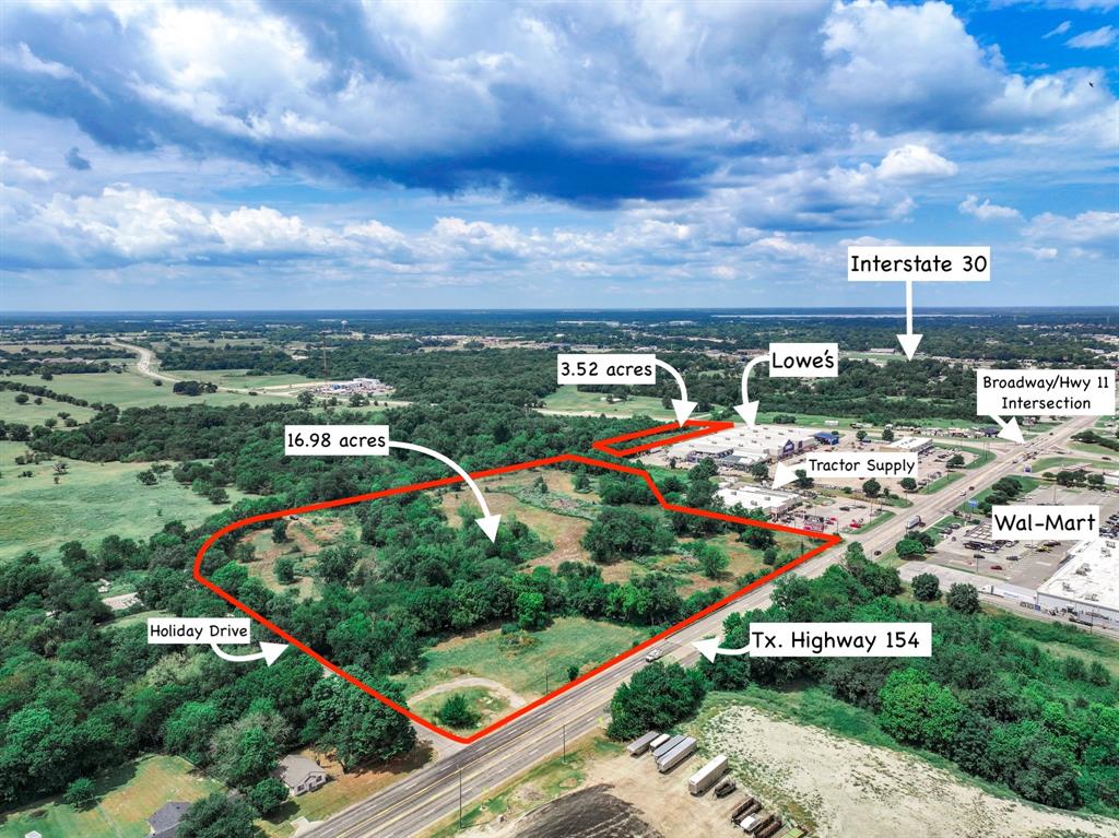Next to Tractor Supply and Lowes and across from Walmart, sits this 20.5 acres with road frontage on 3 sides including Highway 154 (aka Broadway Street) on the east side! Property also has frontage on Highway 11 (aka Wildcat Way) from the north and Holiday Drive from the west. For utilities, there is an 18-inch sewer line on the property, plus access to a 2-inch water line and 8-inch water line that is close by. Per Texas Department of Transportation, the Daily Traffic count on Highway 154 is 8,625 and 9,268 on Highway 11. Acreage is inside the city limits and zoned Heavy Commercial. A Billboard is also included with property. Total income from property is $1,950 per month. Discover the investment potential this acreage has to offer--next to Lowes and Tractor Supply, near Walmart, a shopping strip mall, and major commercial businesses and restaurant chains!